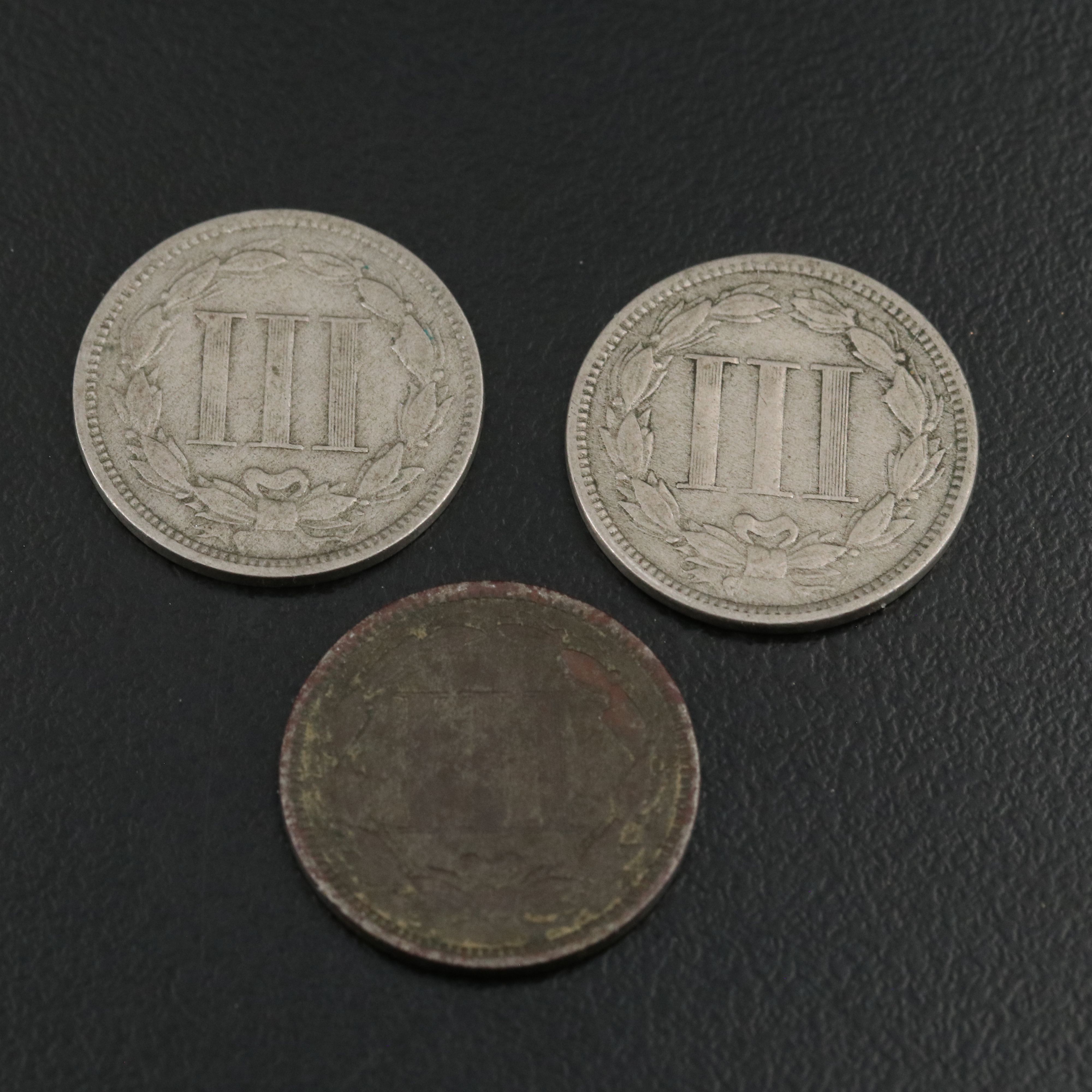 7 different U.S. three cent nickels 1865, 1866, 1867, 1868, 1869, 1870, and 1974