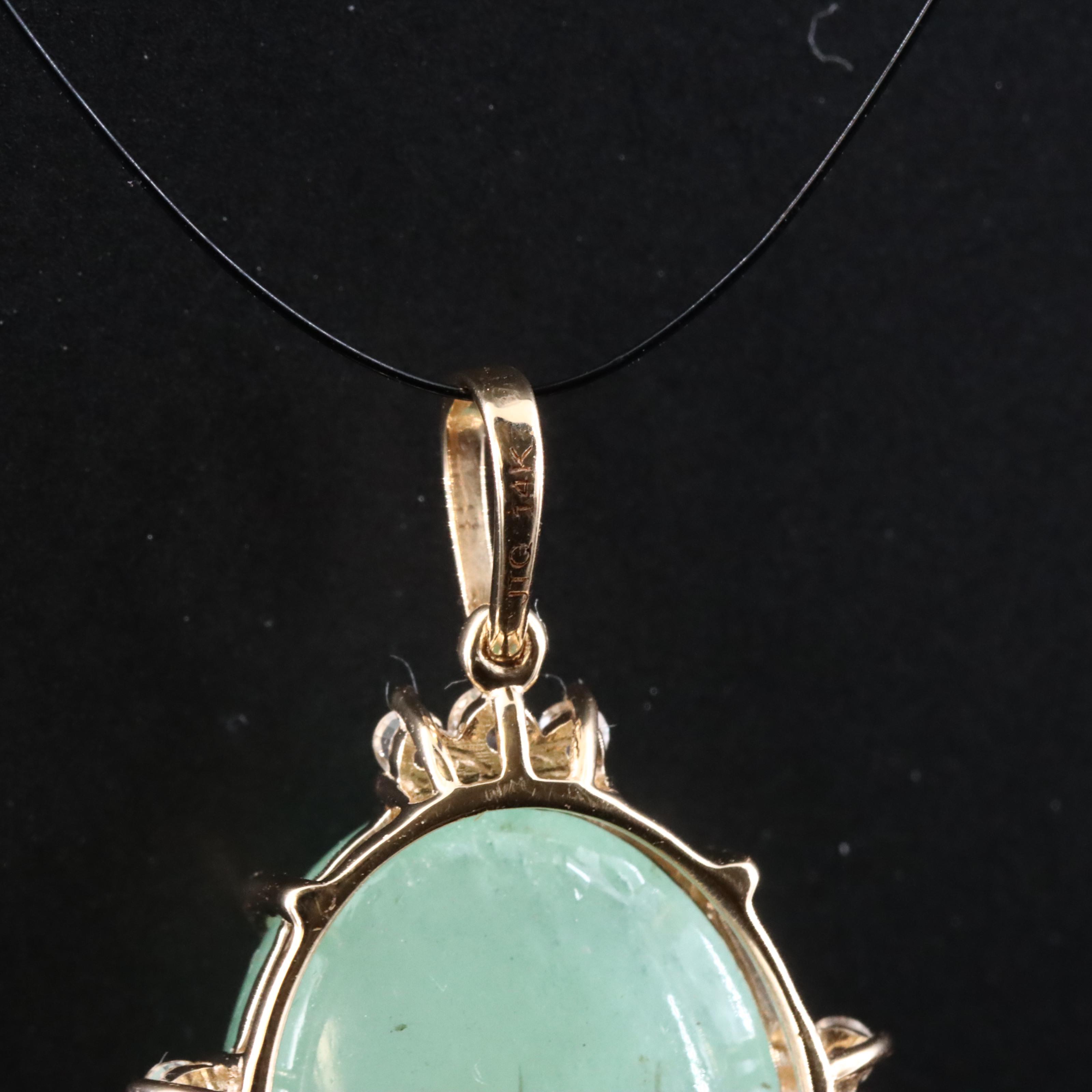 14K 10.96 CT Emerald Pendant with White Sapphire and White Topaz Accents