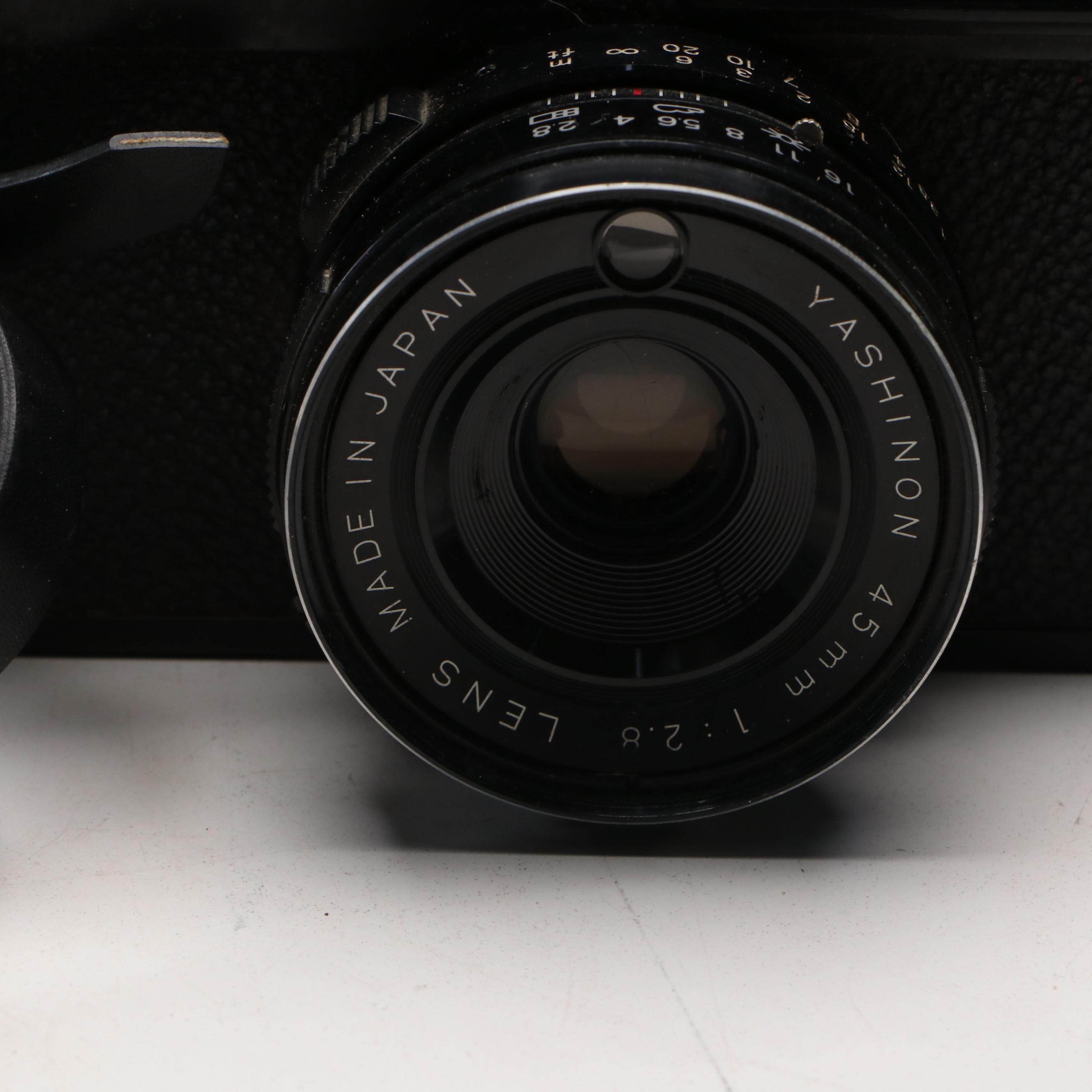 Collection of SLR Film Cameras with Hard Case and Other Accessories