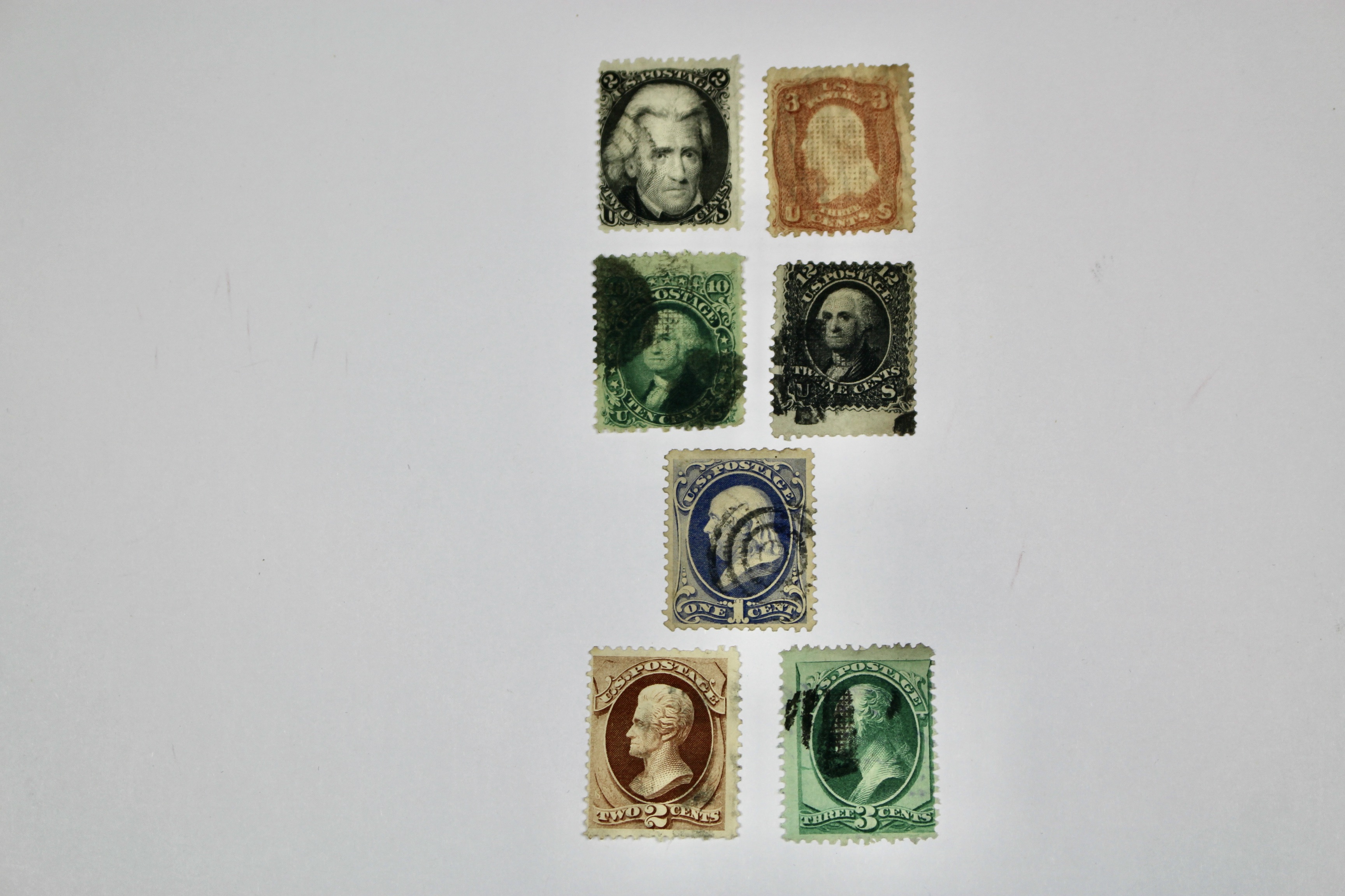 Seven Early U.S. Postage Stamps, All with Grills