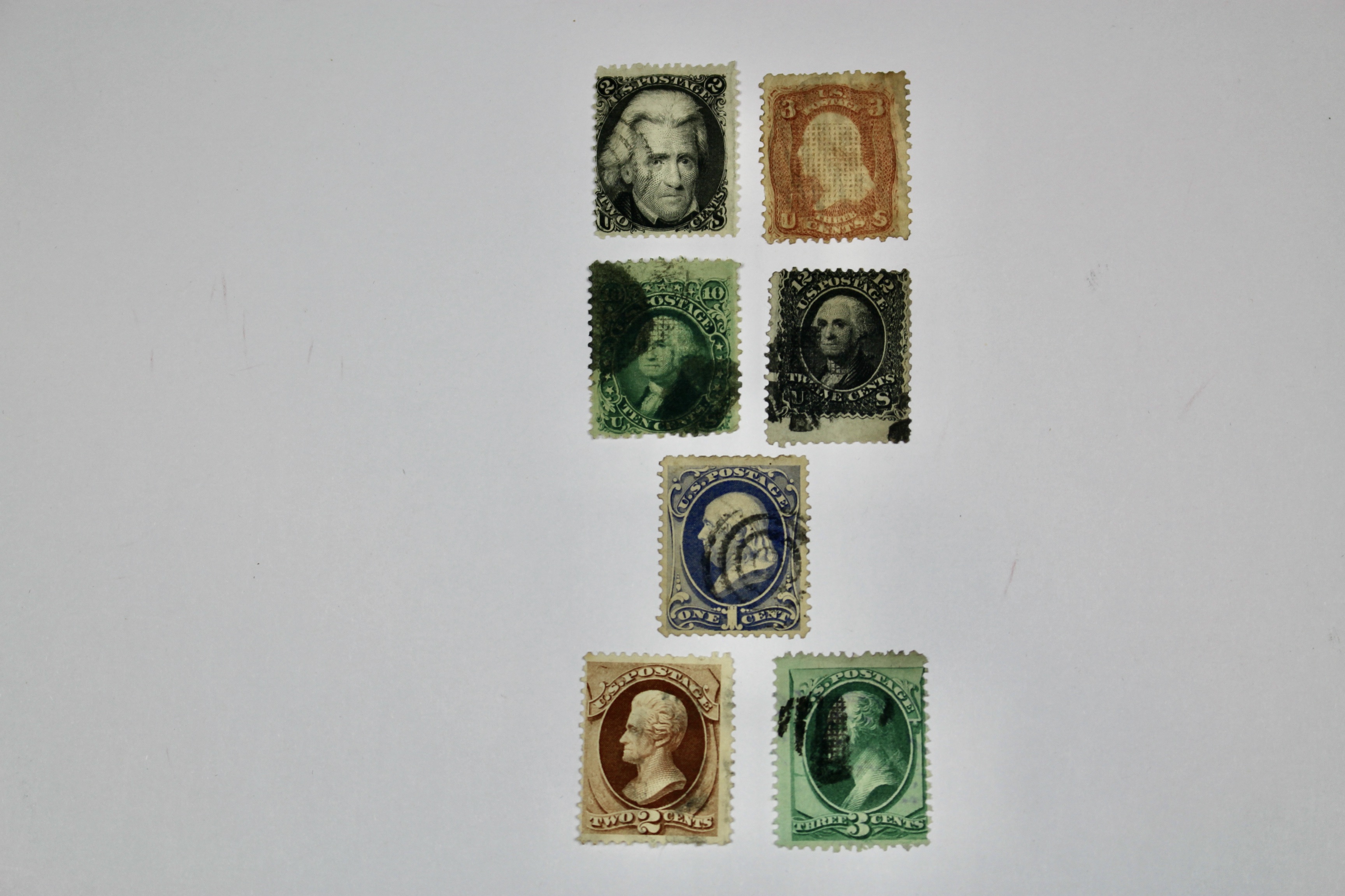 Seven Early U.S. Postage Stamps, All with Grills