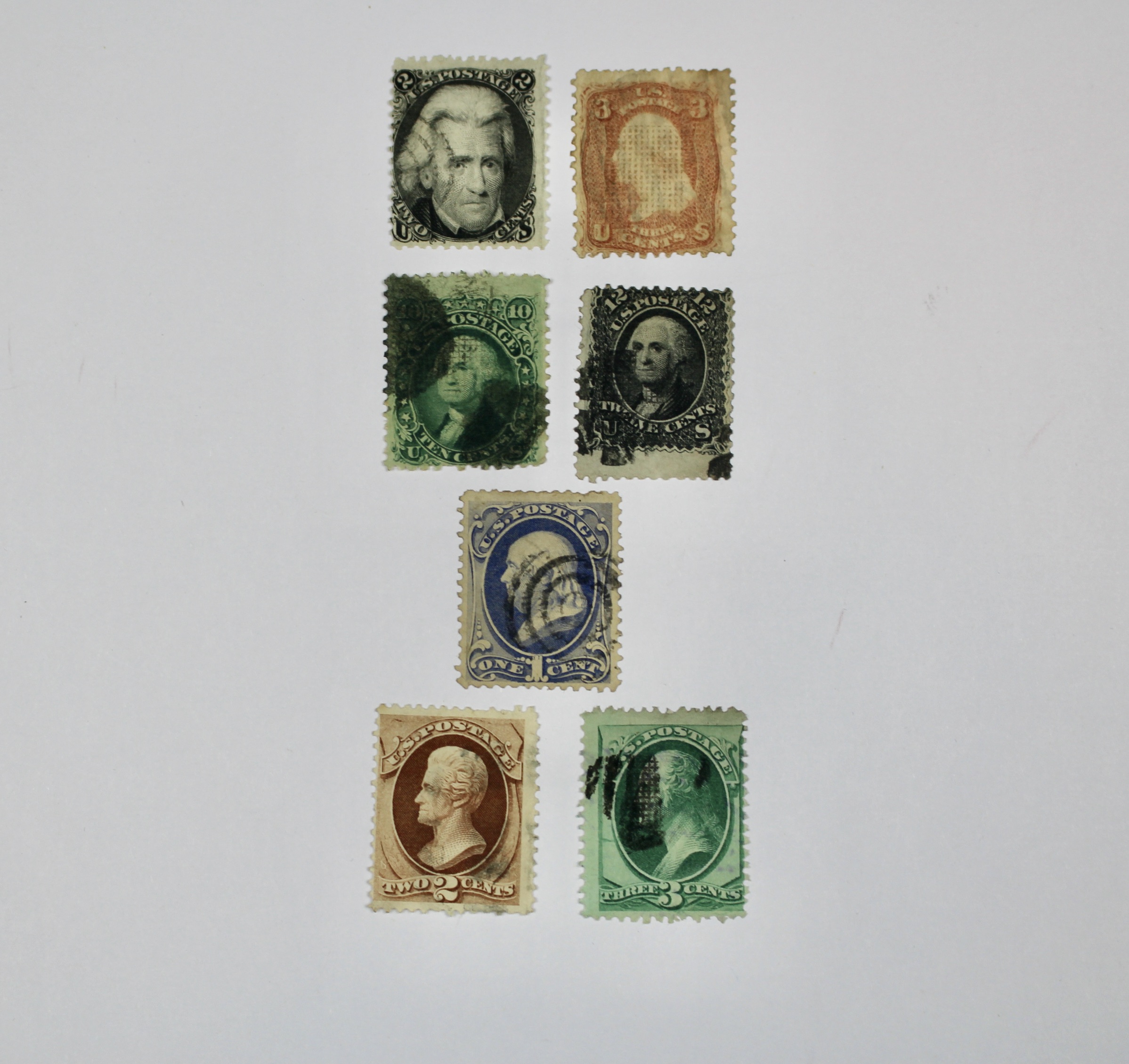 Seven Early U.S. Postage Stamps, All with Grills