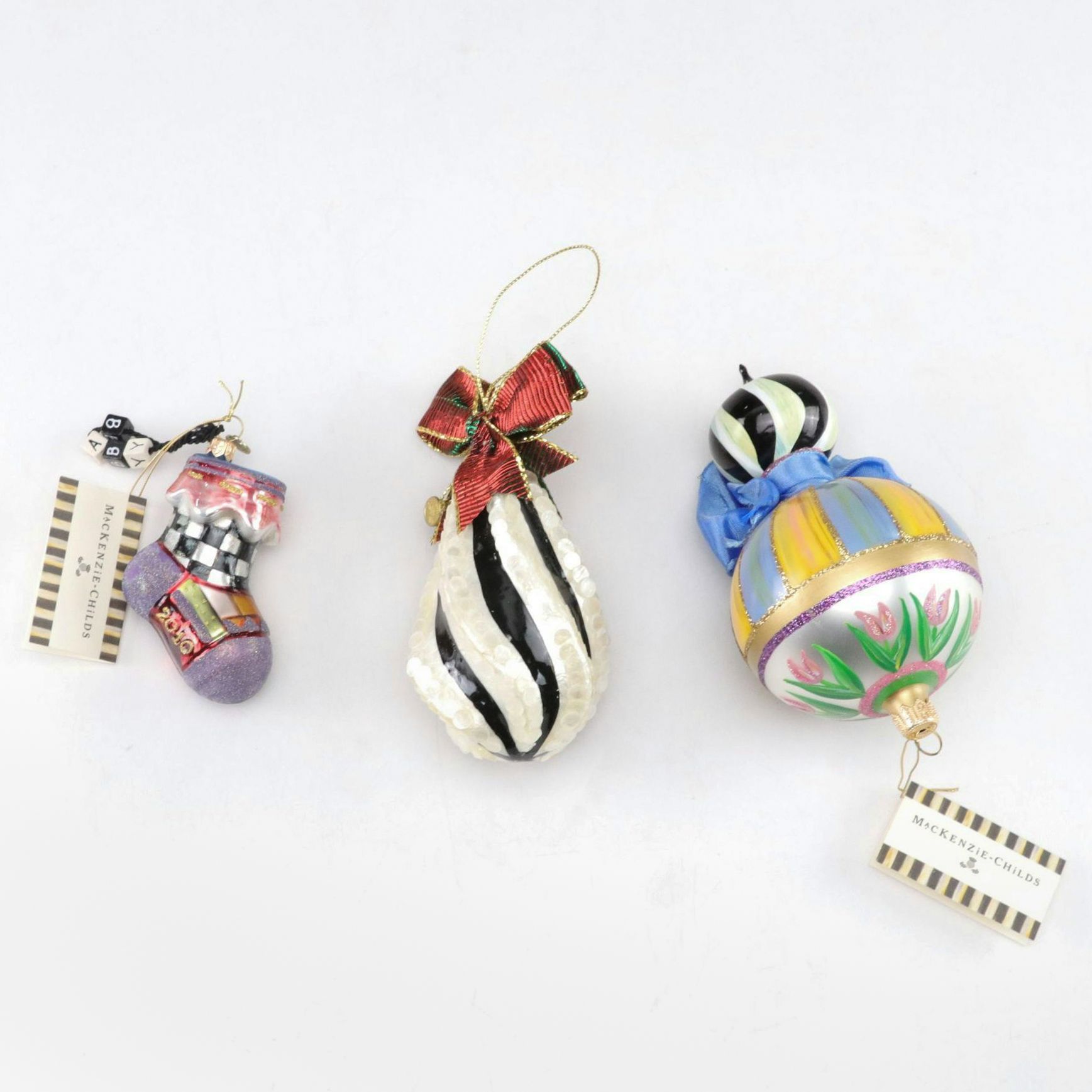 Three MacKenzie-Childs Blown Glass Christmas Ornaments with "First Christmas"