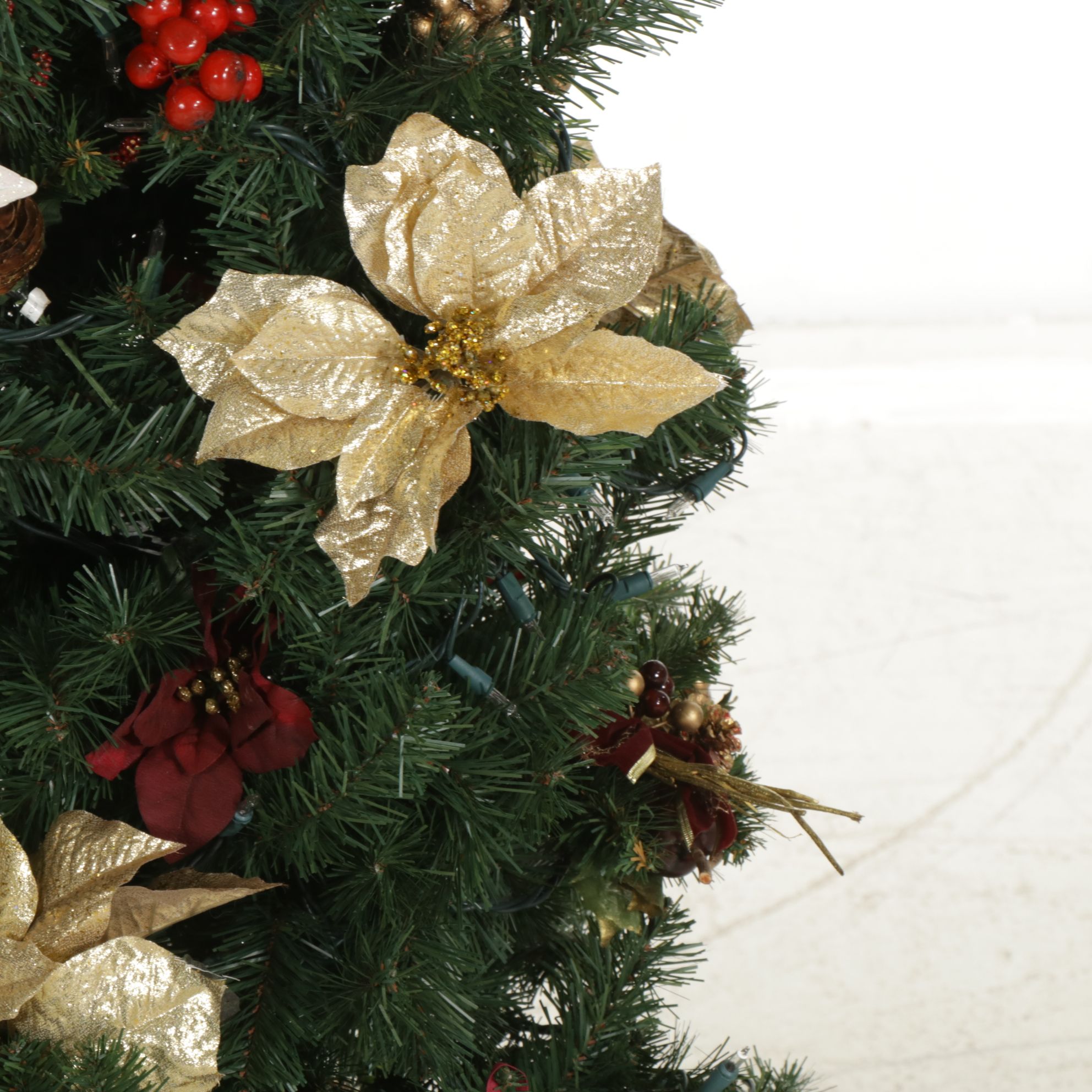 Lighted Artificial Christmas Tree with Poinsettias and Other Ornaments