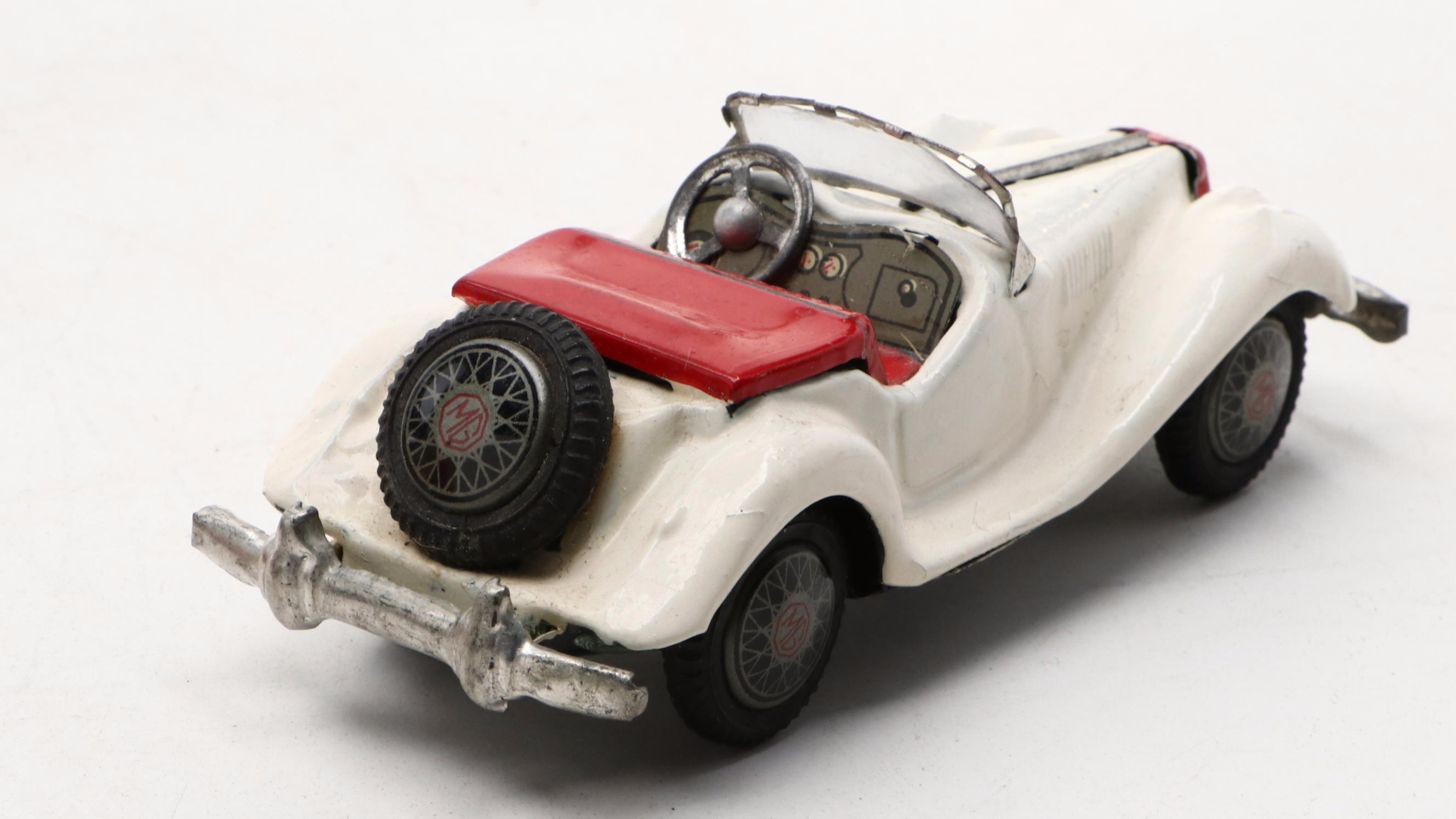 Studebaker Tin Wind-Up Car with More Vintage Toy Cars and Boat