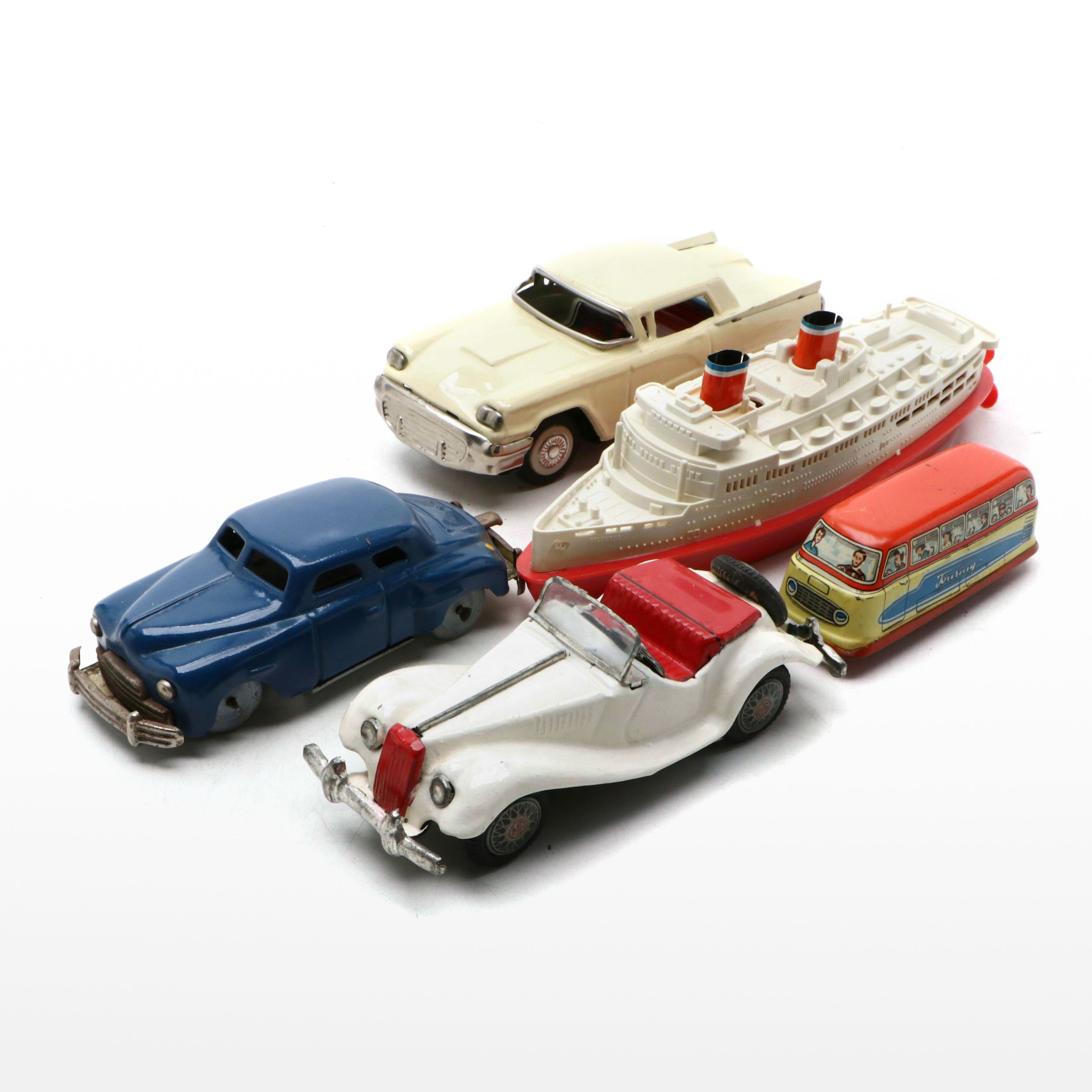 Studebaker Tin Wind-Up Car with More Vintage Toy Cars and Boat
