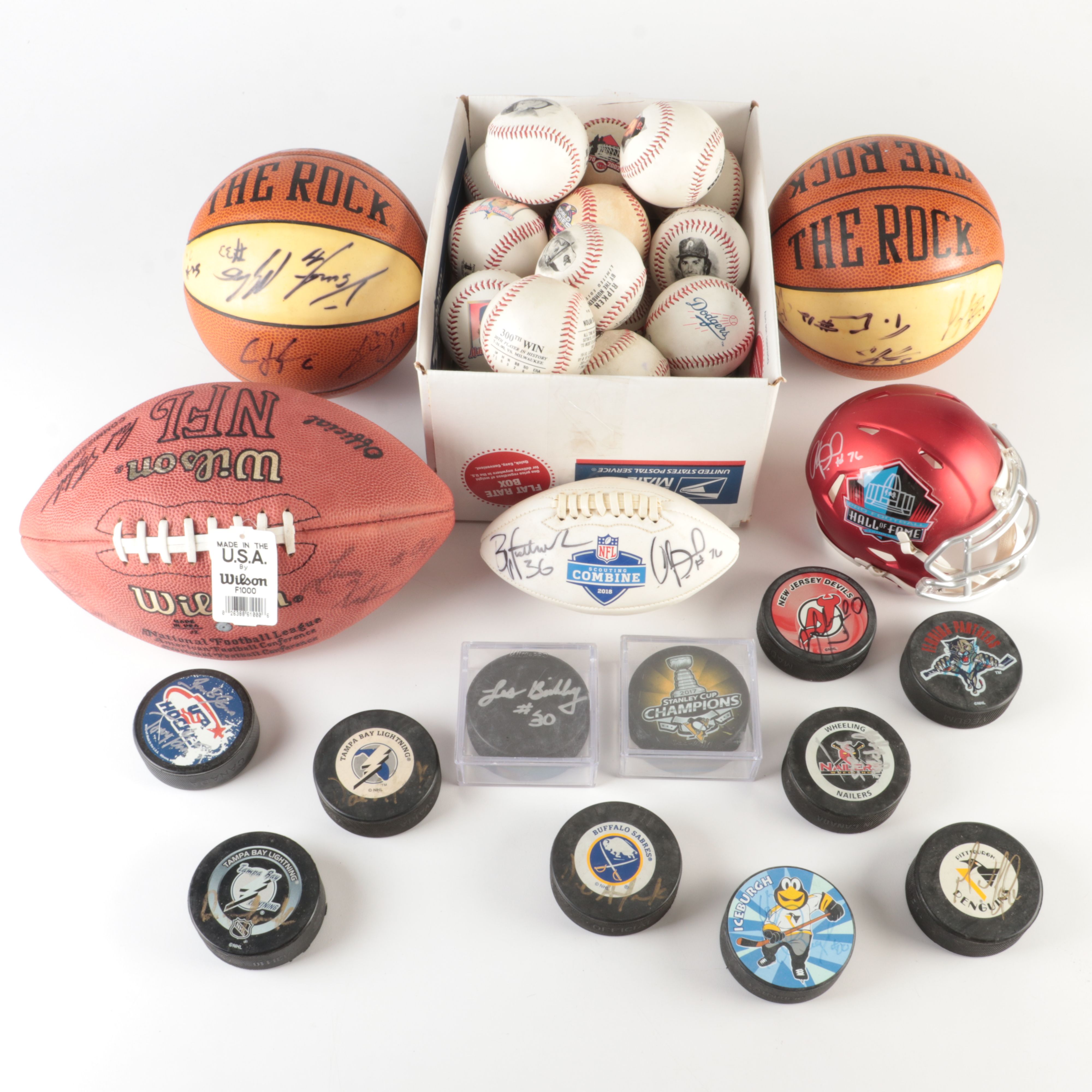Collection off Signed Footballs, Hockey Pucks, Basketballs, and More