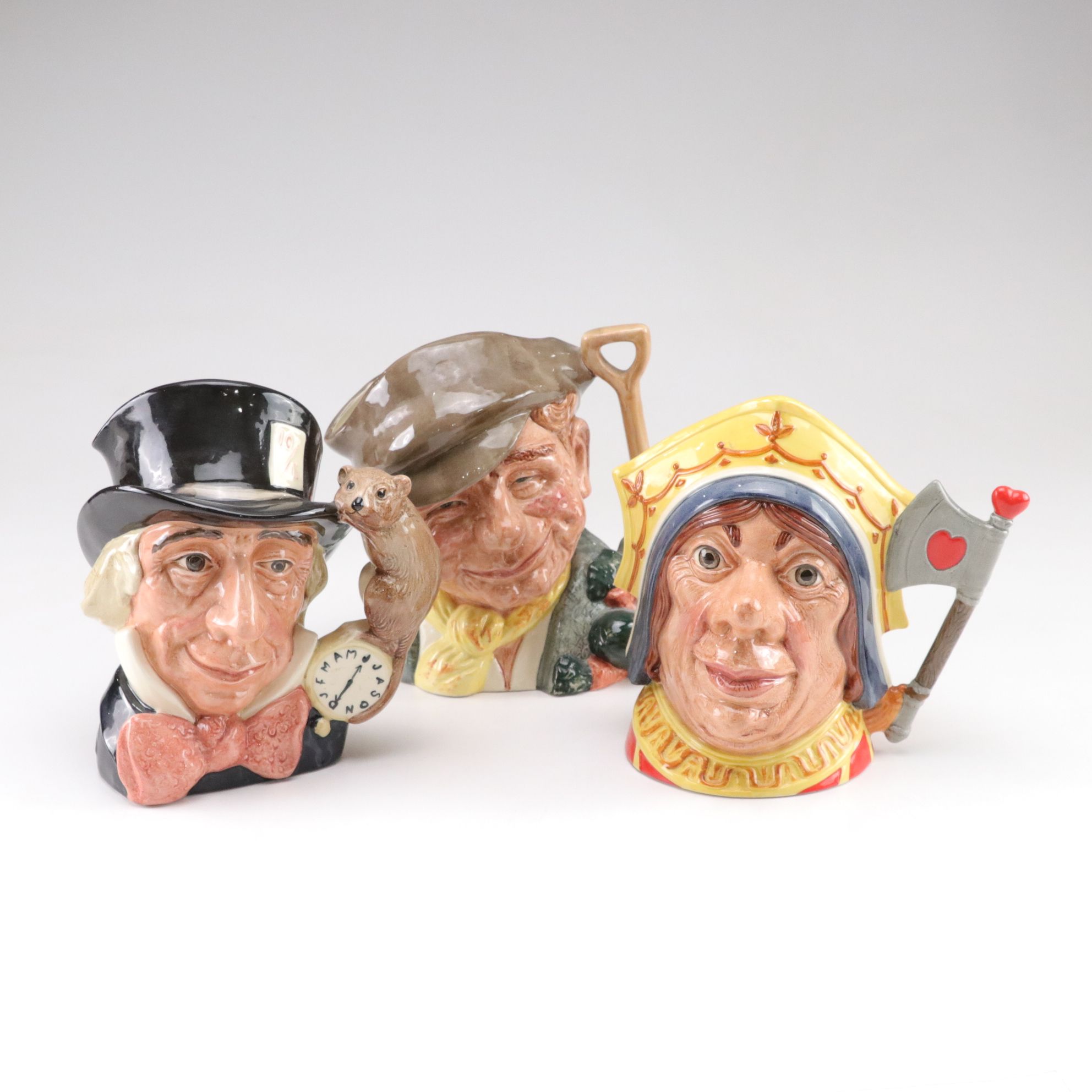 Royal Doulton Toby Jugs "The Mad Hatter", "The Red Queen", and "The Gardener"