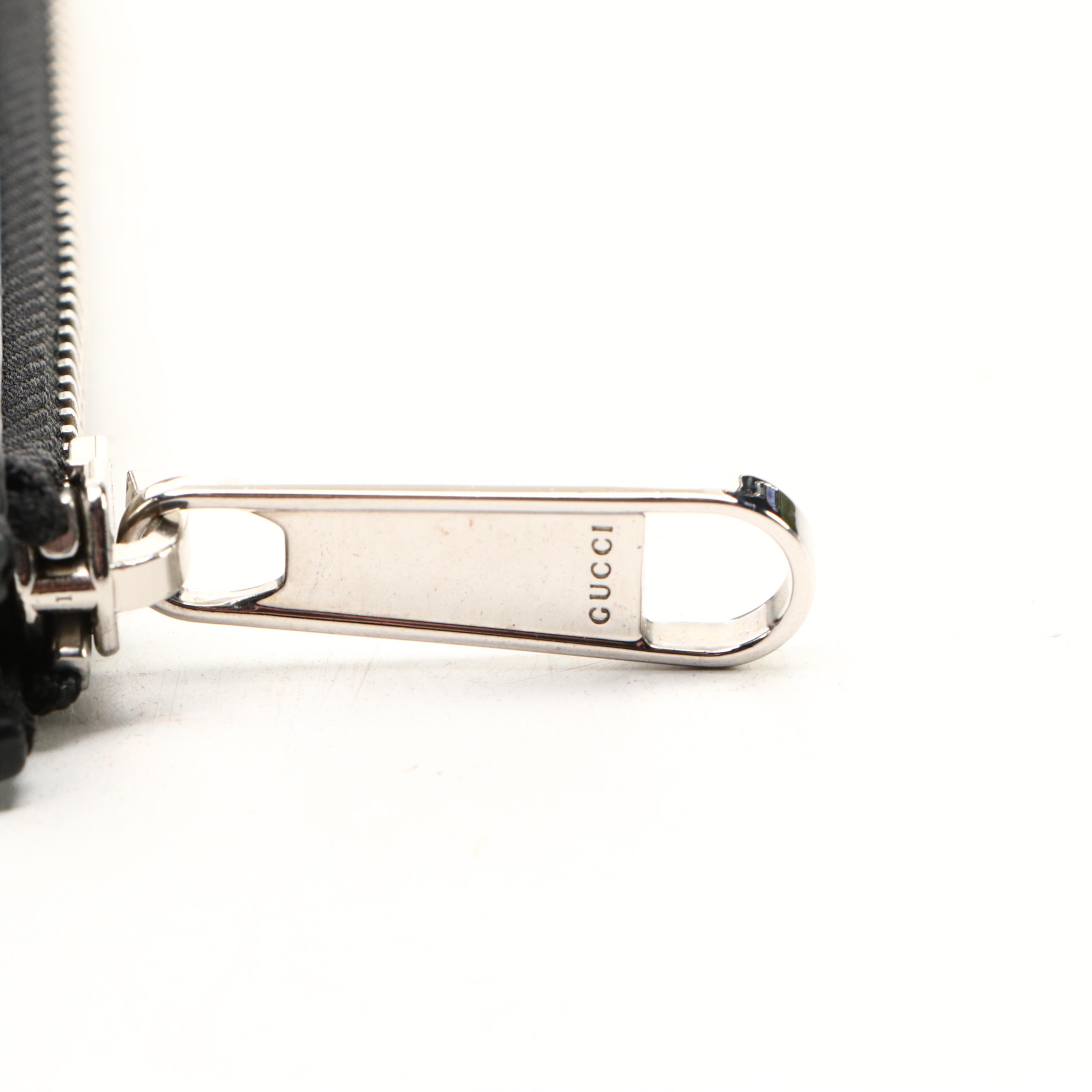 Gucci Zip Wristlet Clutch in Black Perforated GG Embossed Leather