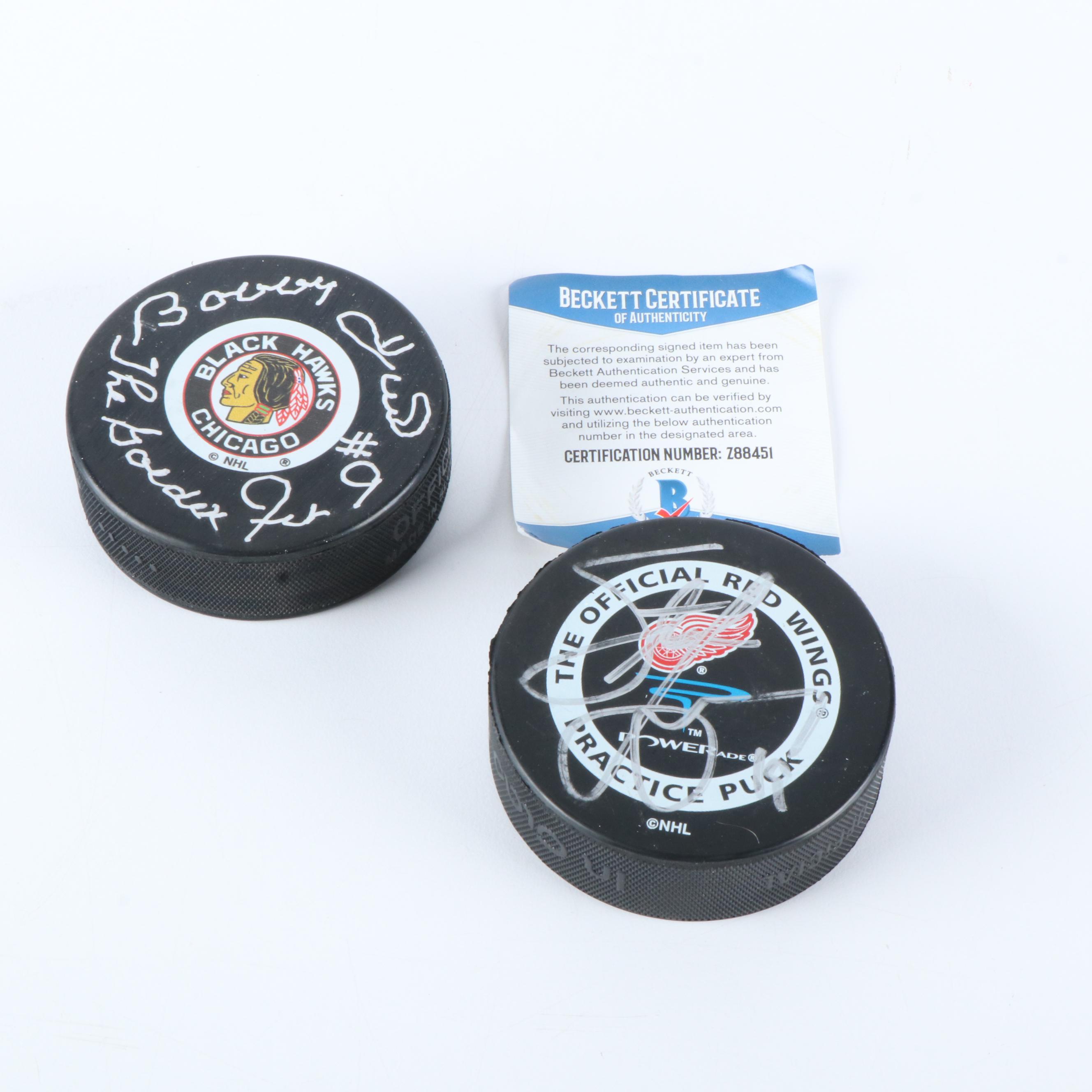 Bobby Hull and Steve Yzerman Signed NHL Hockey Pucks, Beckett