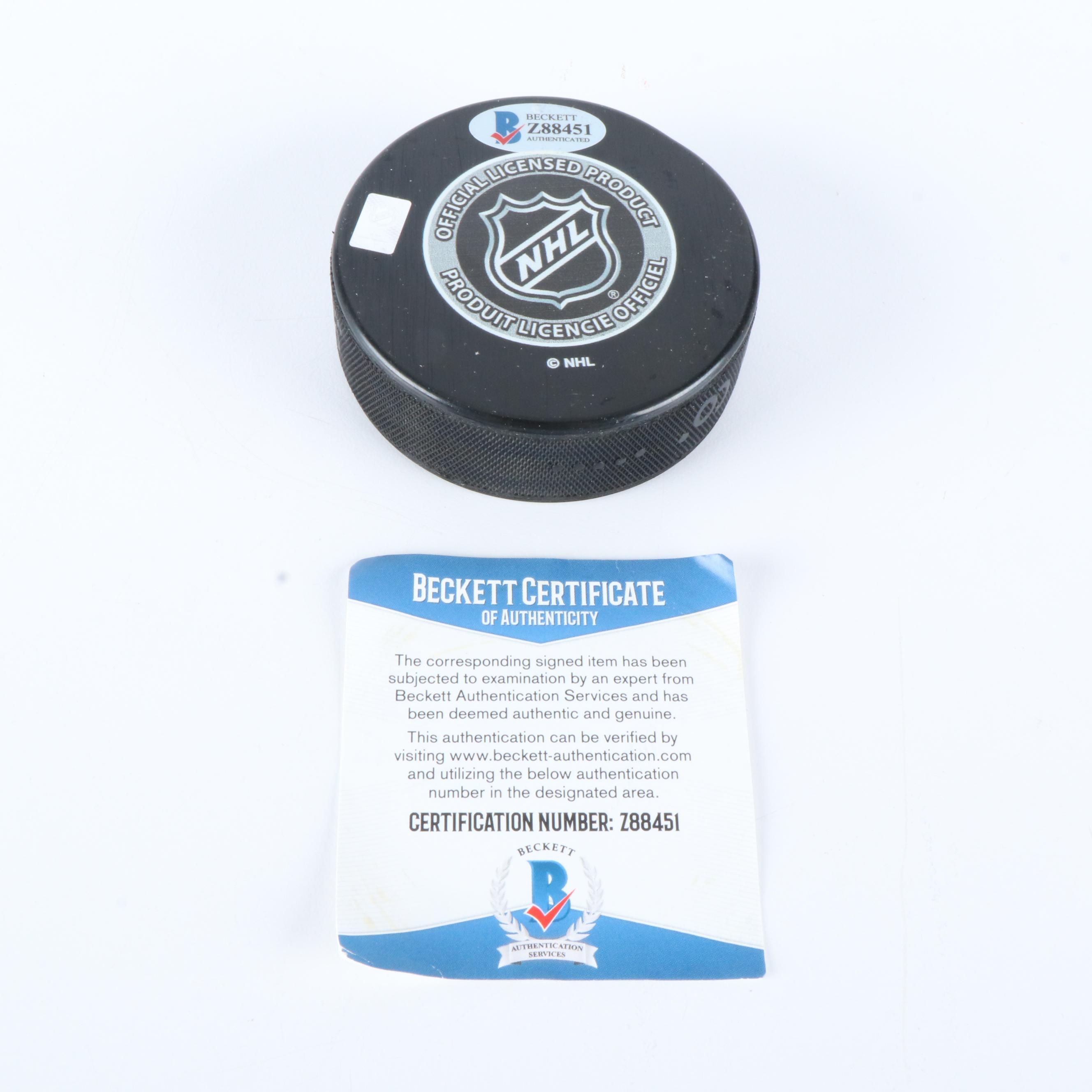 Bobby Hull and Steve Yzerman Signed NHL Hockey Pucks, Beckett