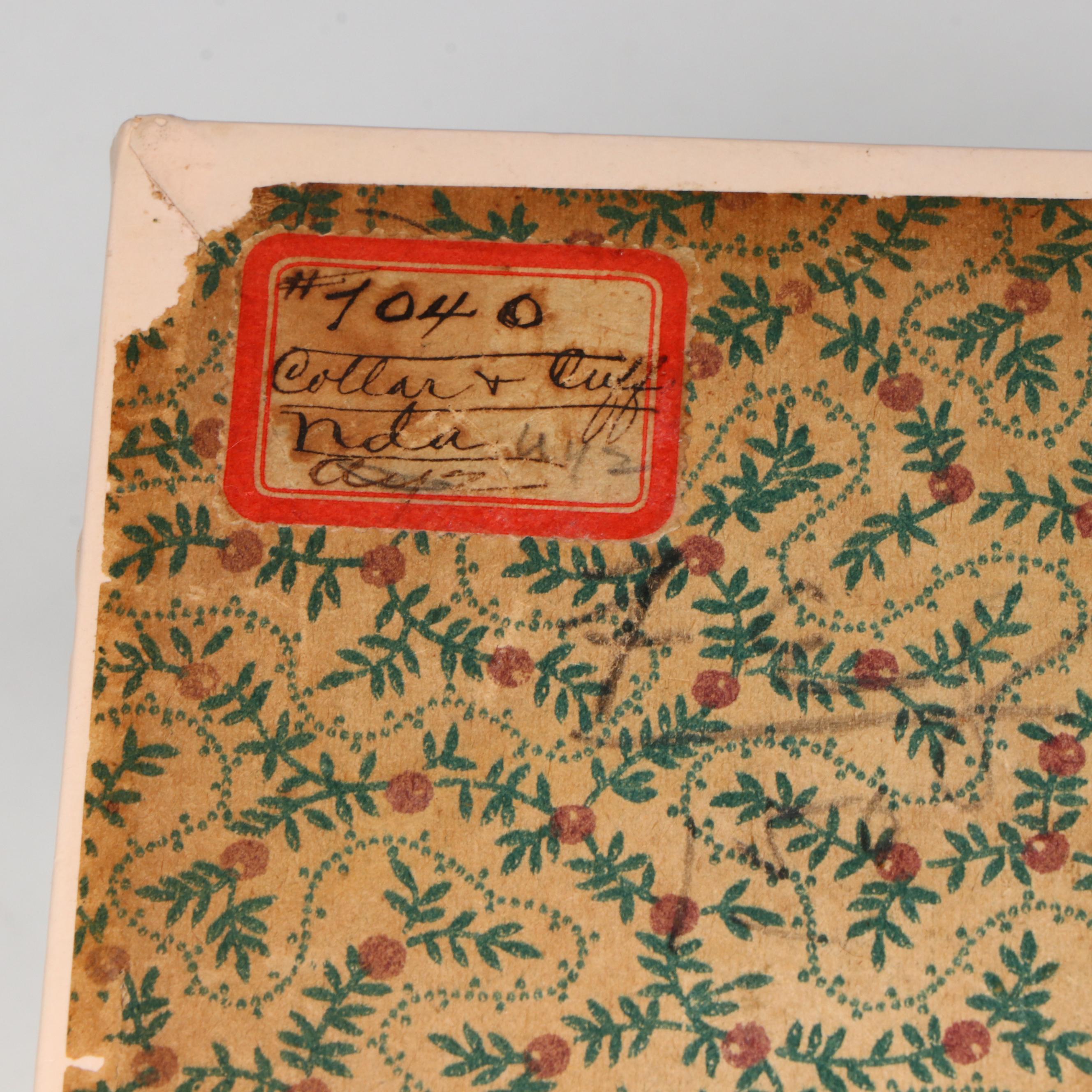 Embossed Pink Collar Box with an Assortment of Starched Collars