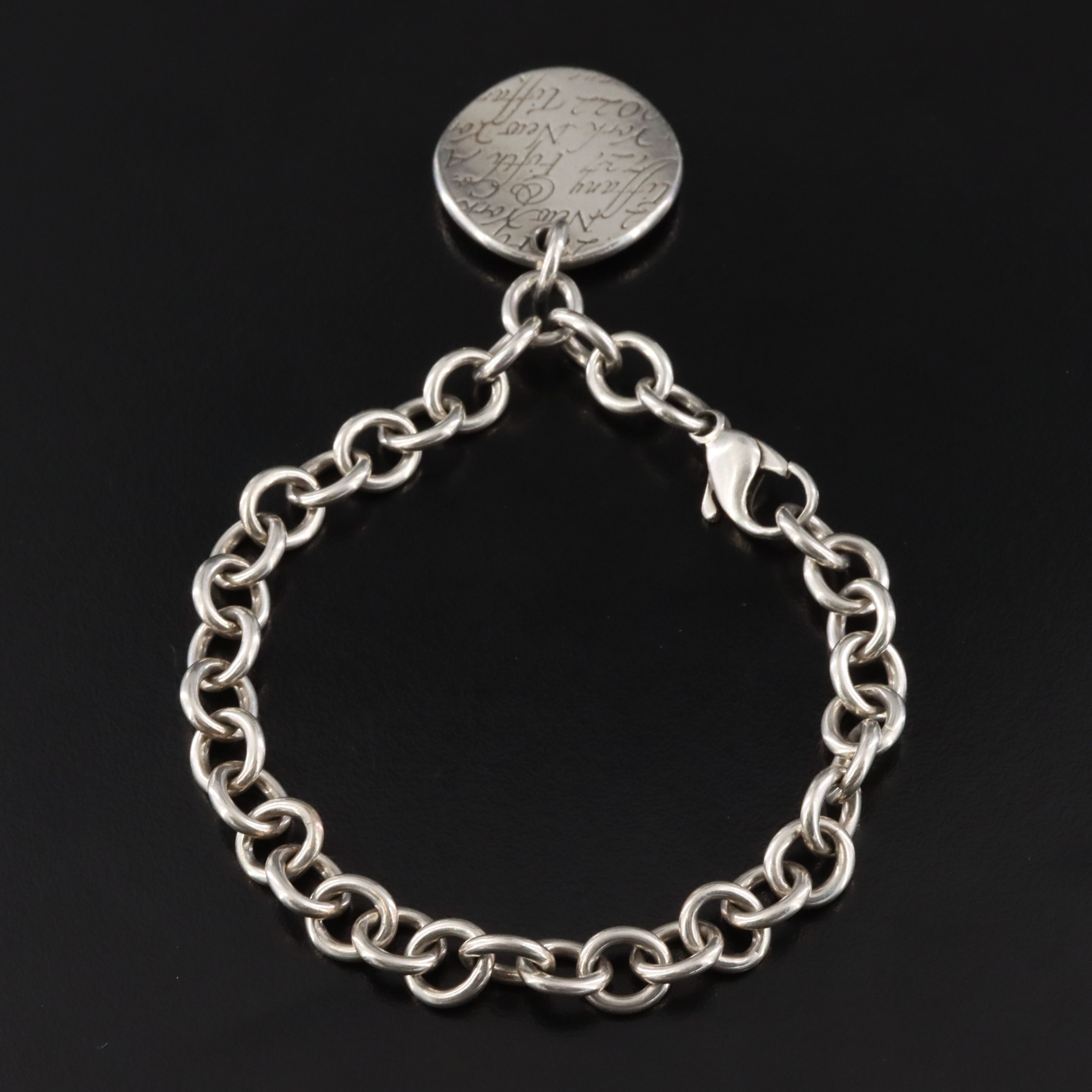 Tiffany & Co. Notes Sterling Round Tag Charm Bracelet