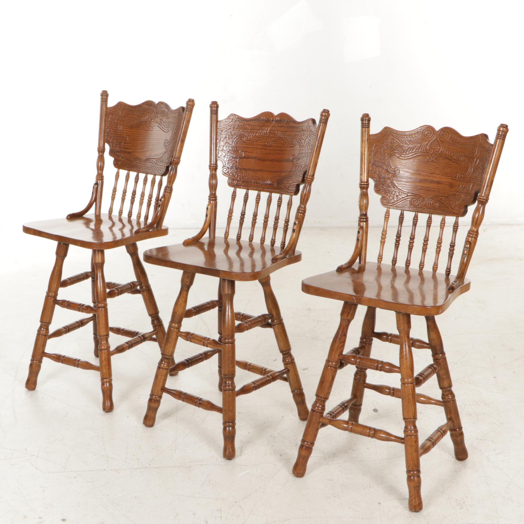 Three Victorian Style Oak Press-Back Swivel Barstools