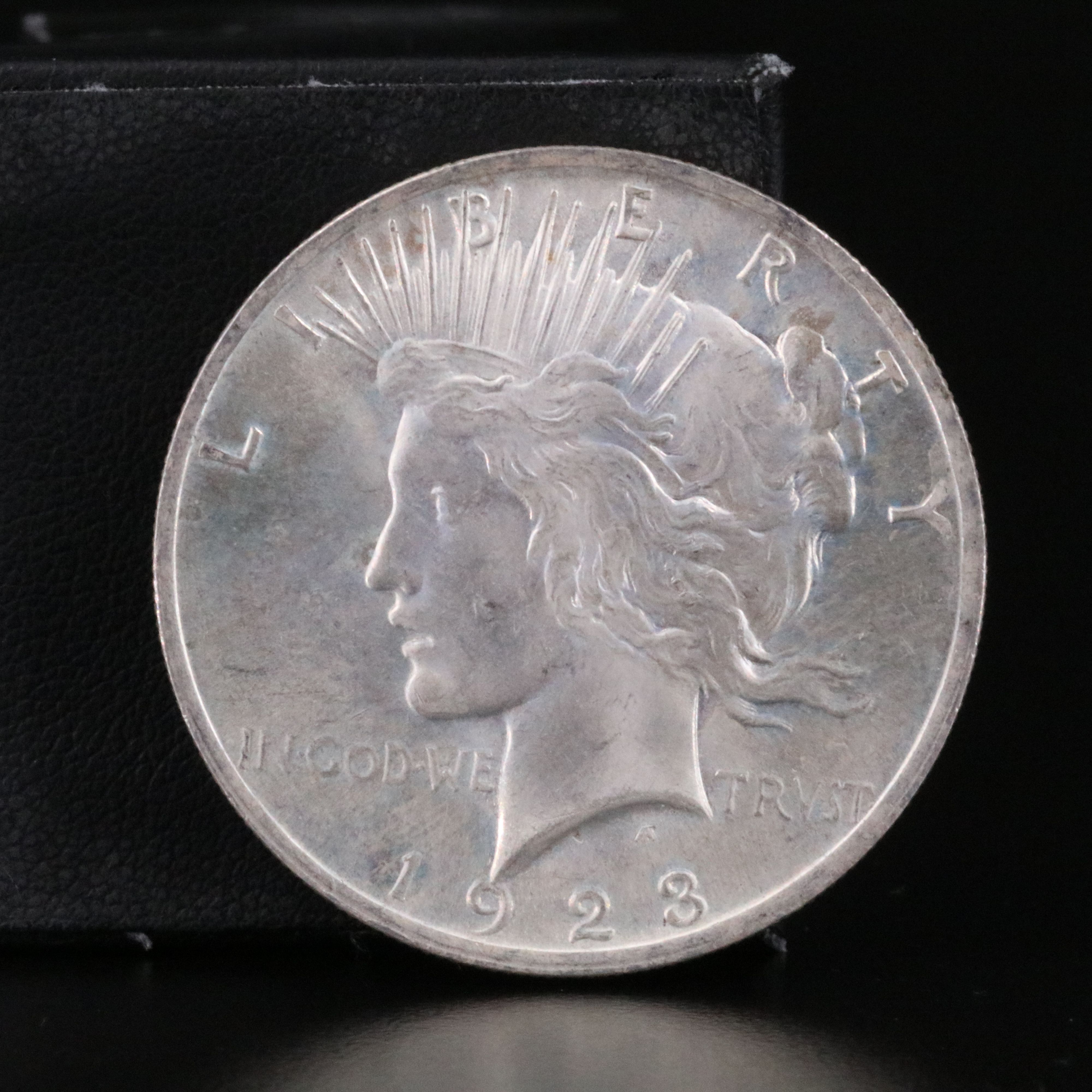 Three Uncirculated  U.S. Morgan and Peace Silver Dollars