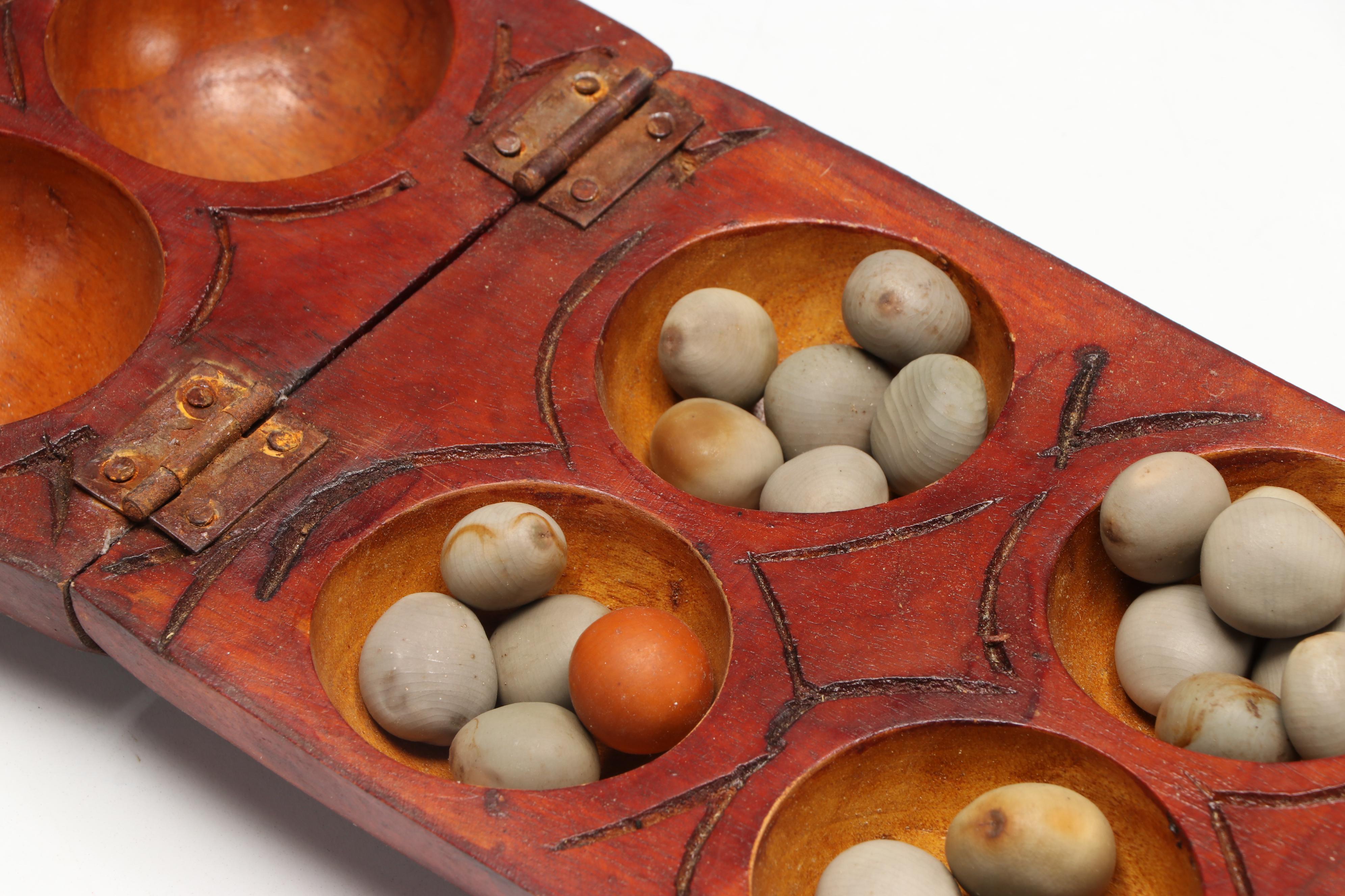 Wood Mancala Board with Seed Game Pieces with Carved Wood Post and Vessel