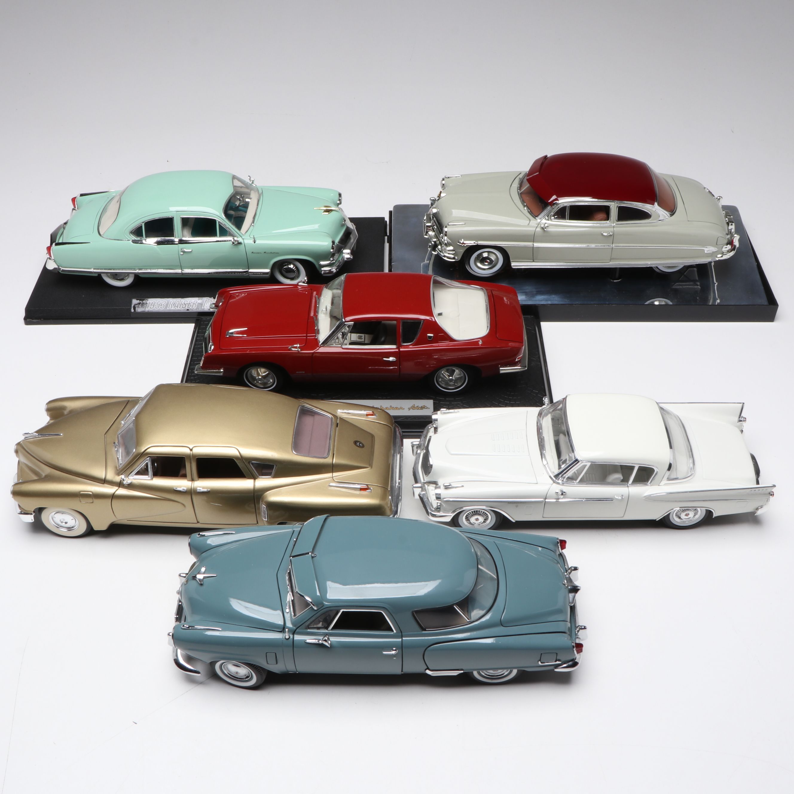 1957 Studebaker Gold Hawk with More Scale Model Diecast Cars and Stands
