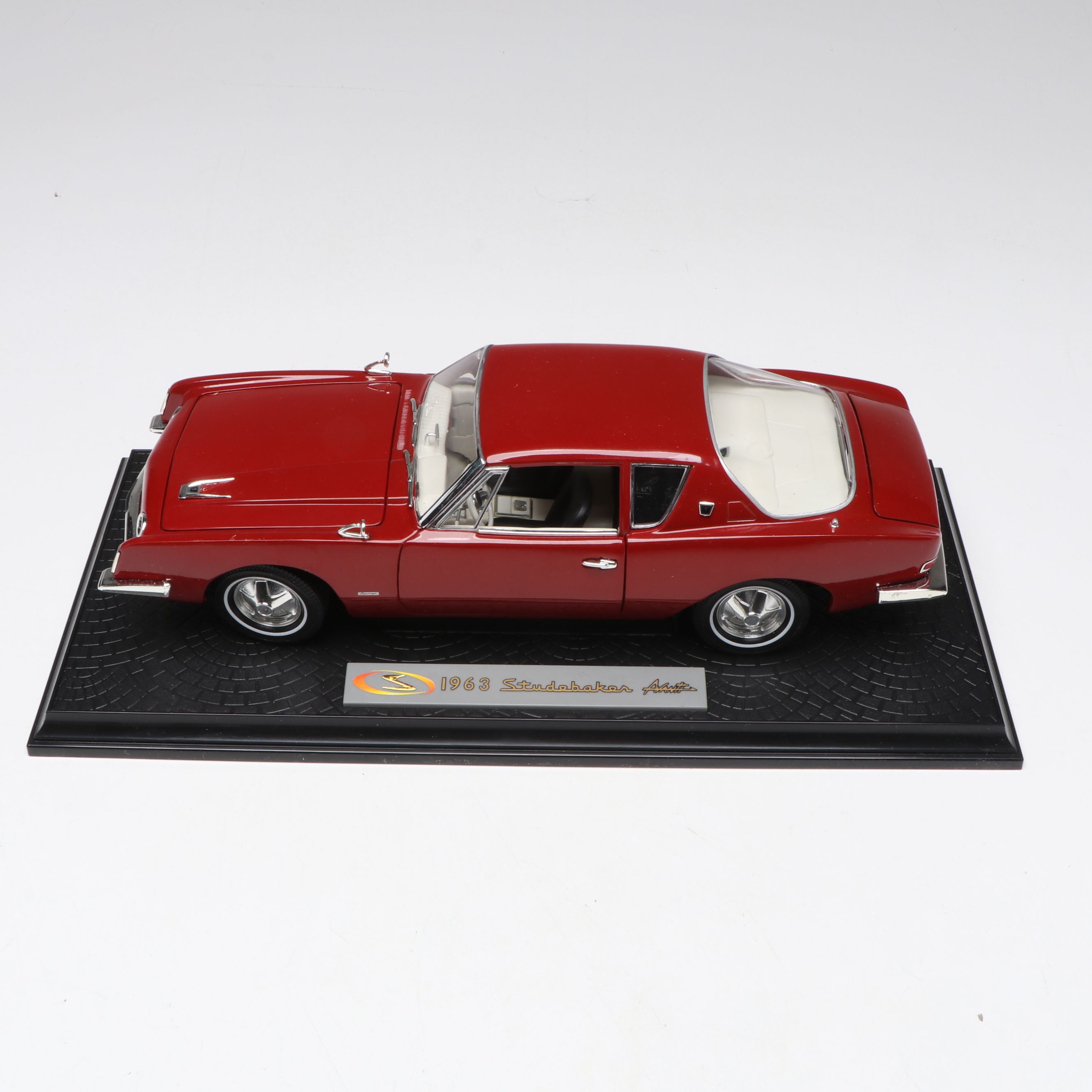 1957 Studebaker Gold Hawk with More Scale Model Diecast Cars and Stands