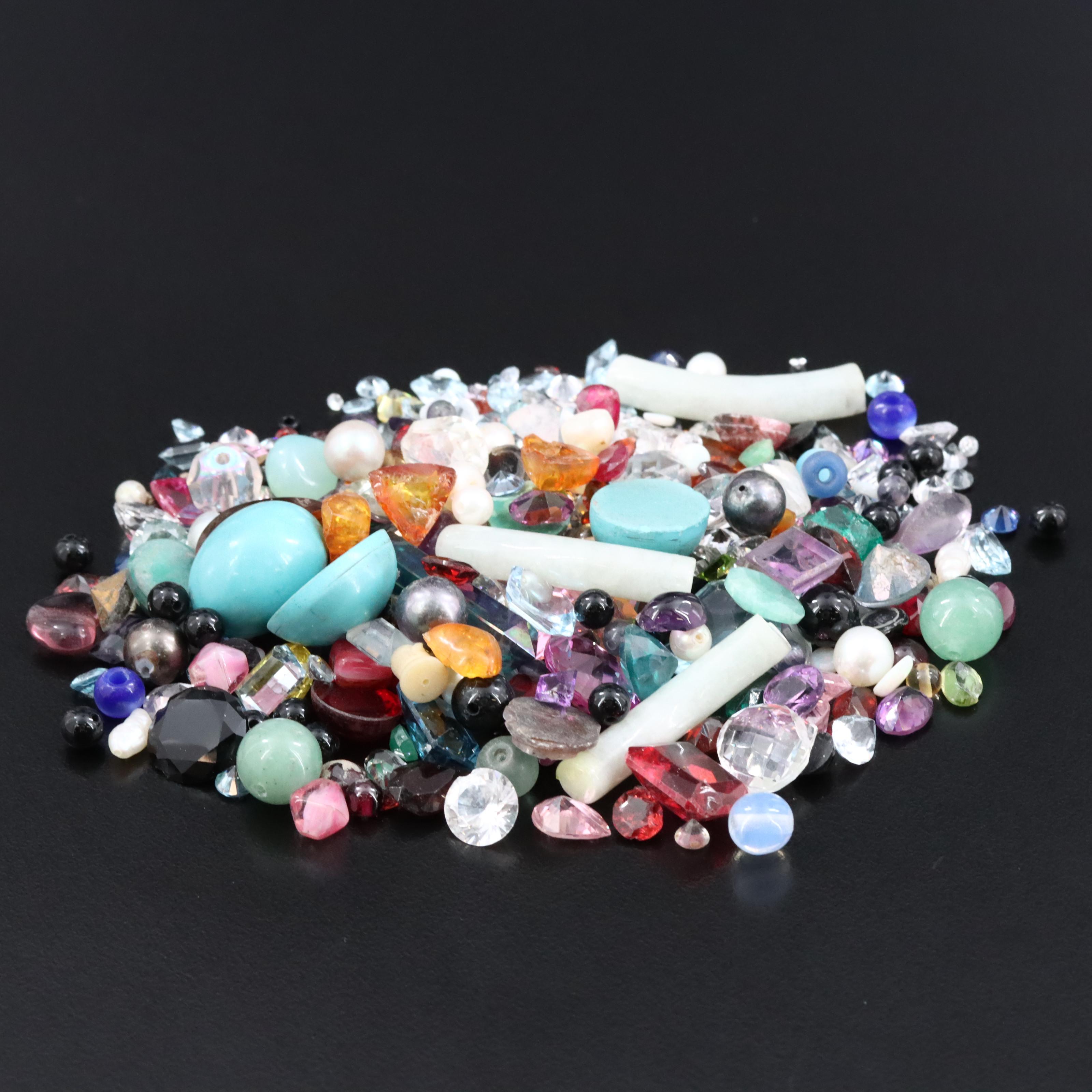 Loose Gemstone Selection Including Aquamarine and Garnets