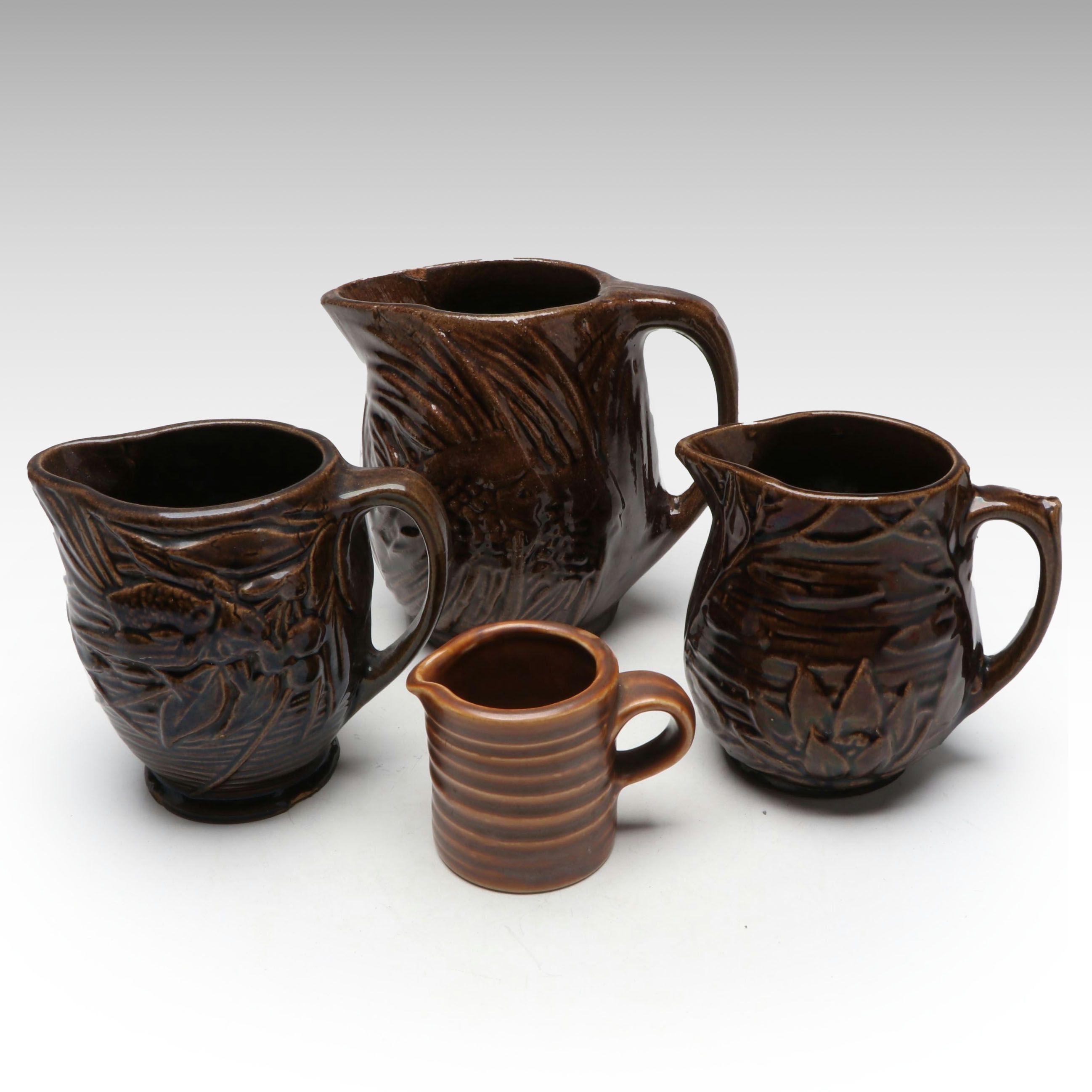 McCoy Pottery Botanical and Aquatic Brown Pitchers with Ribbed Hull Creamer