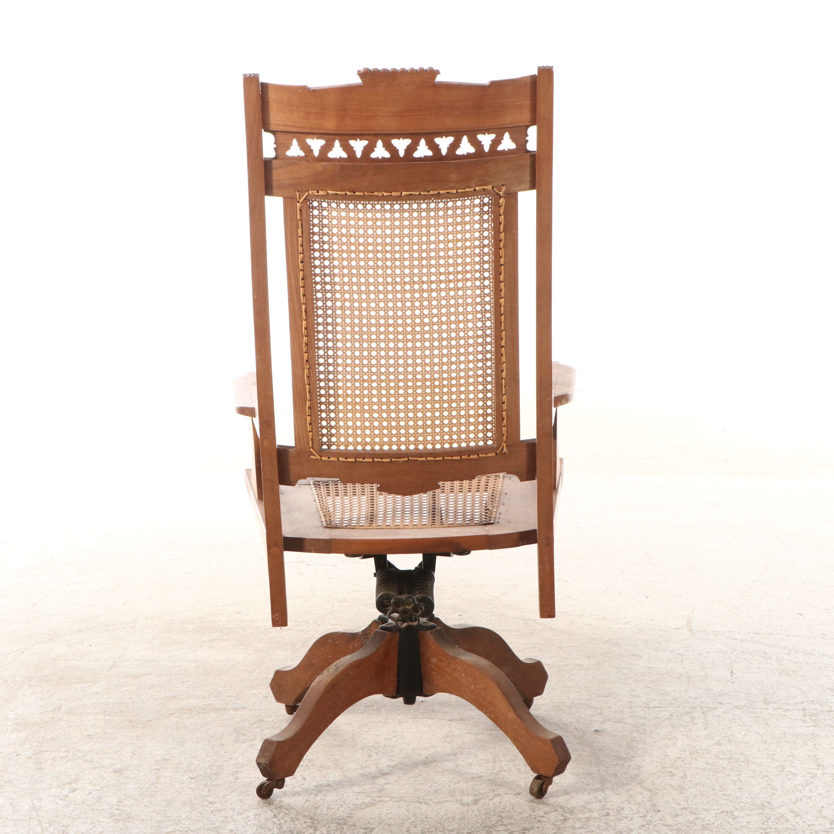 Eastlake Style Carved Walnut and Cane Rolling Desk Chair