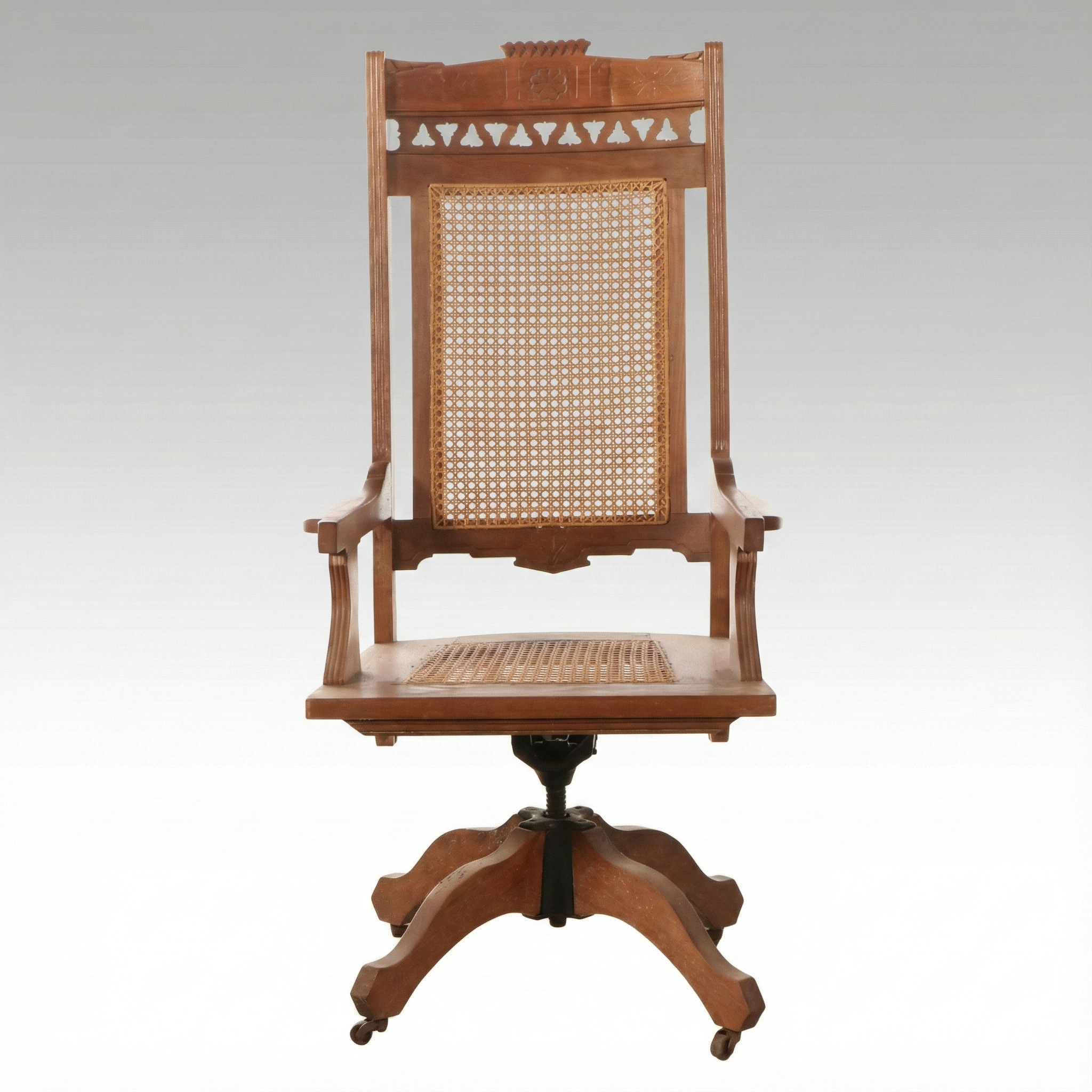 Eastlake Style Carved Walnut and Cane Rolling Desk Chair