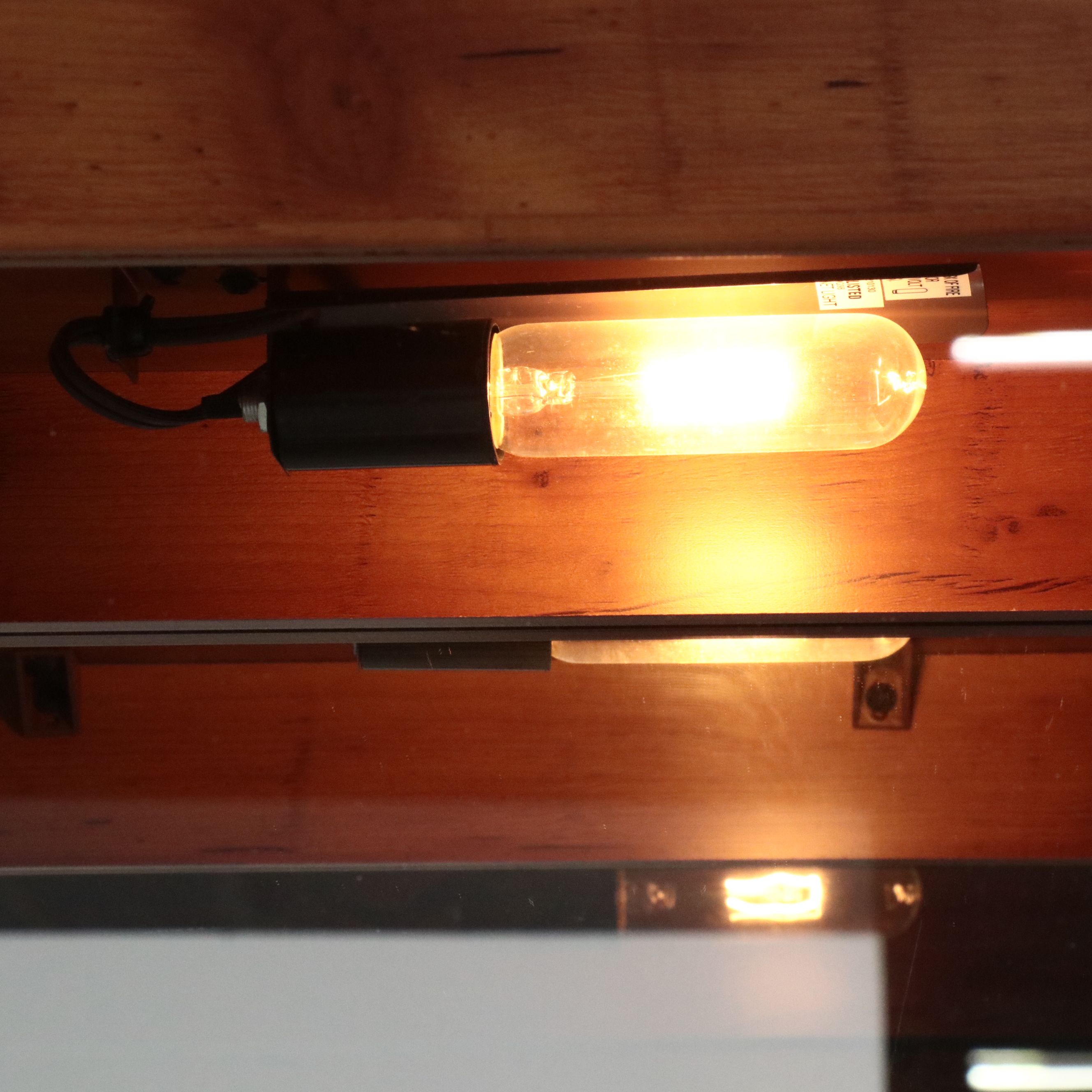 Illuminated Pine Curio Cabinet with Scrolled Metal Accent