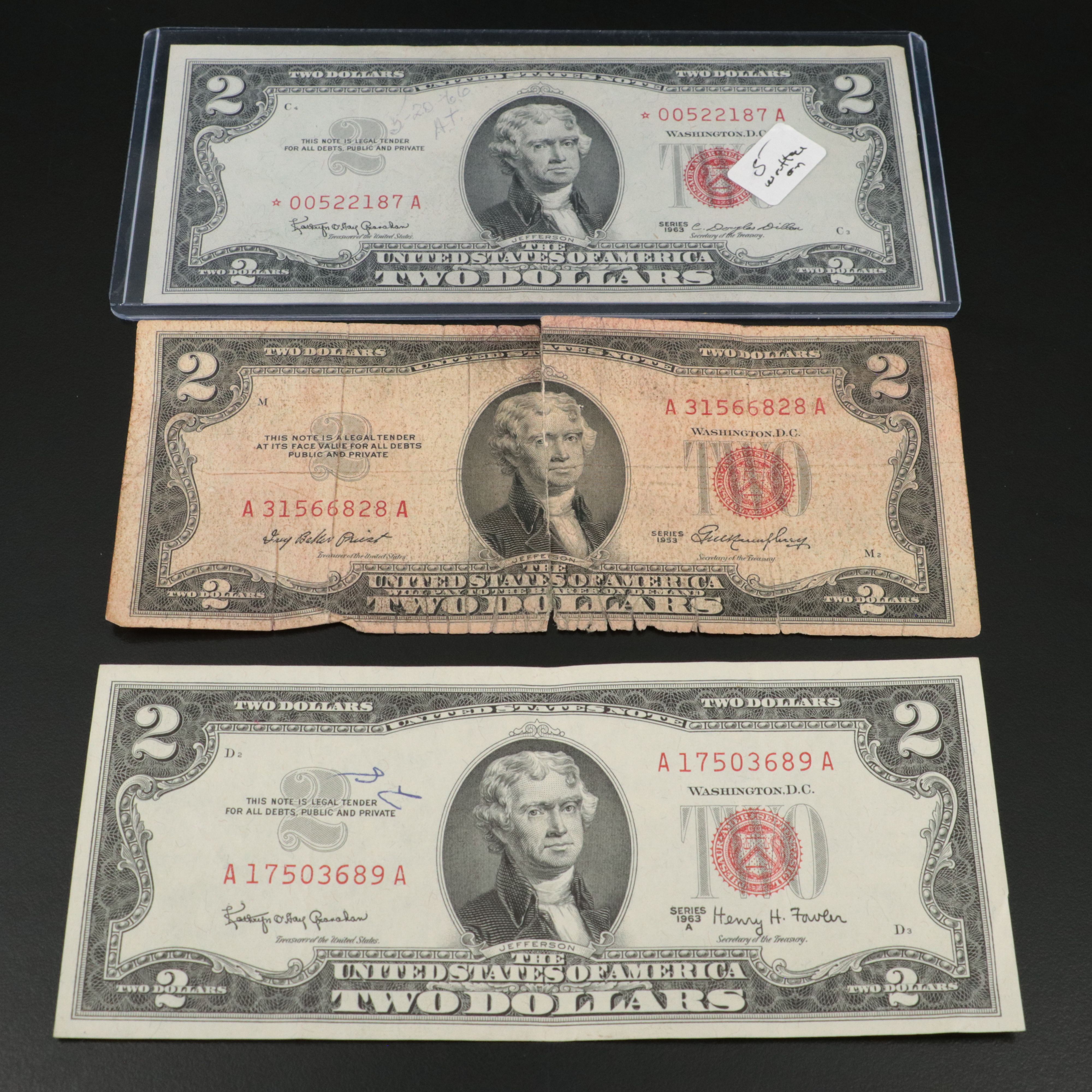 Sixteen U.S. Currency Notes with Writing on Them