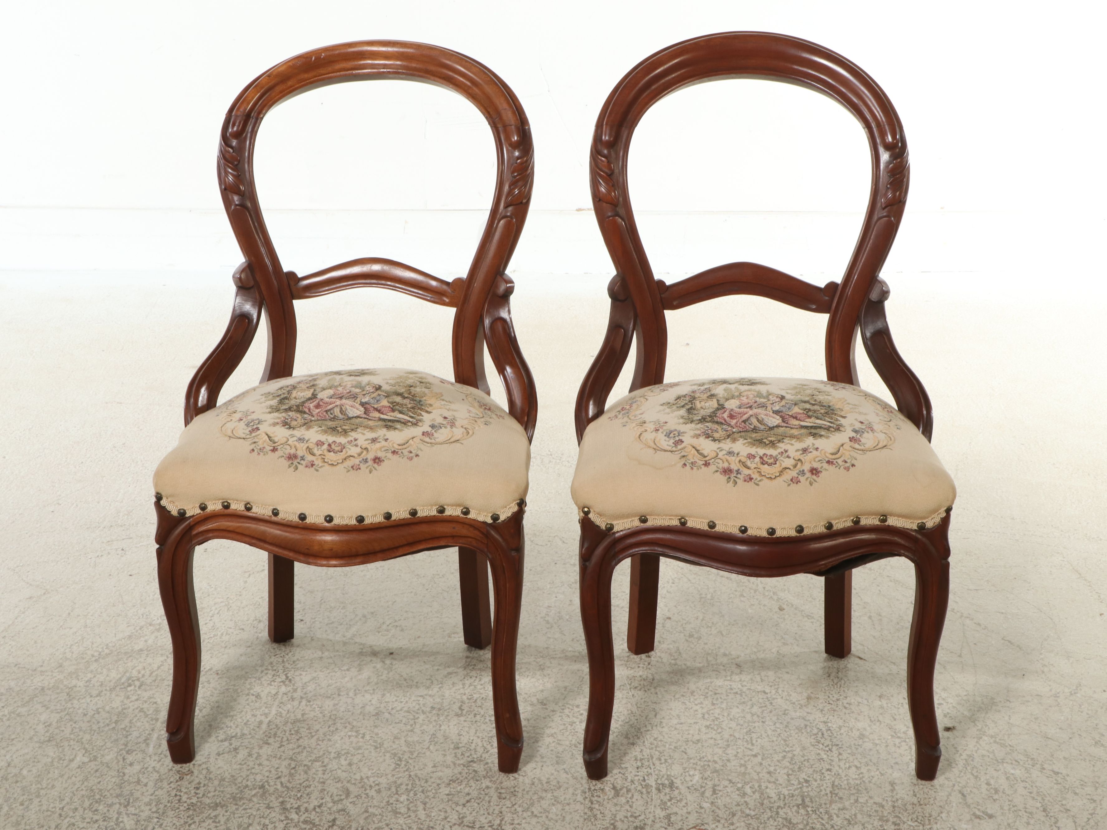 Pair of Victorian Style Carved Walnut Balloon Back Chairs with Needlepoint Seats