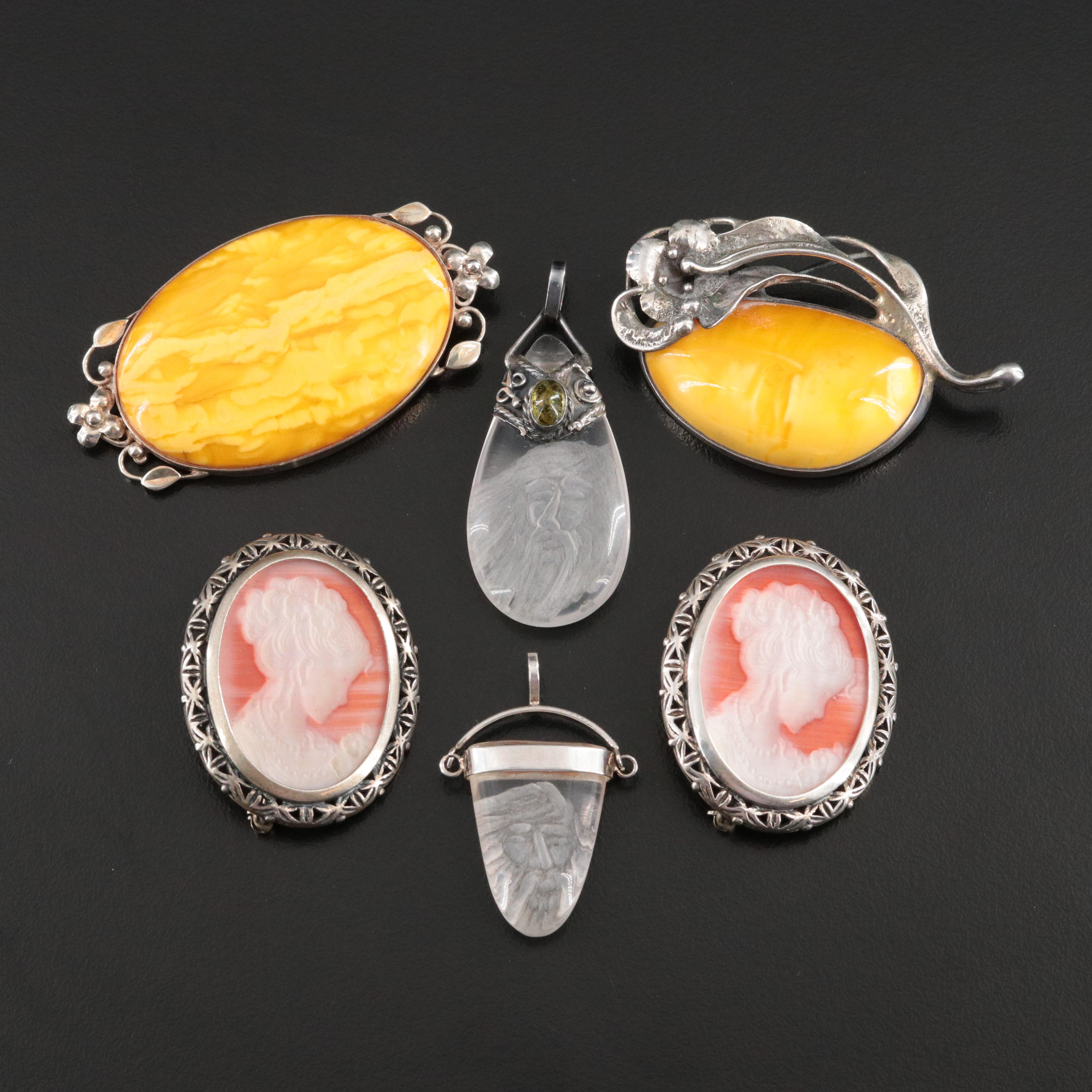 Sterling Brooches and Pendants Including Carved Rock Crystal and Amber
