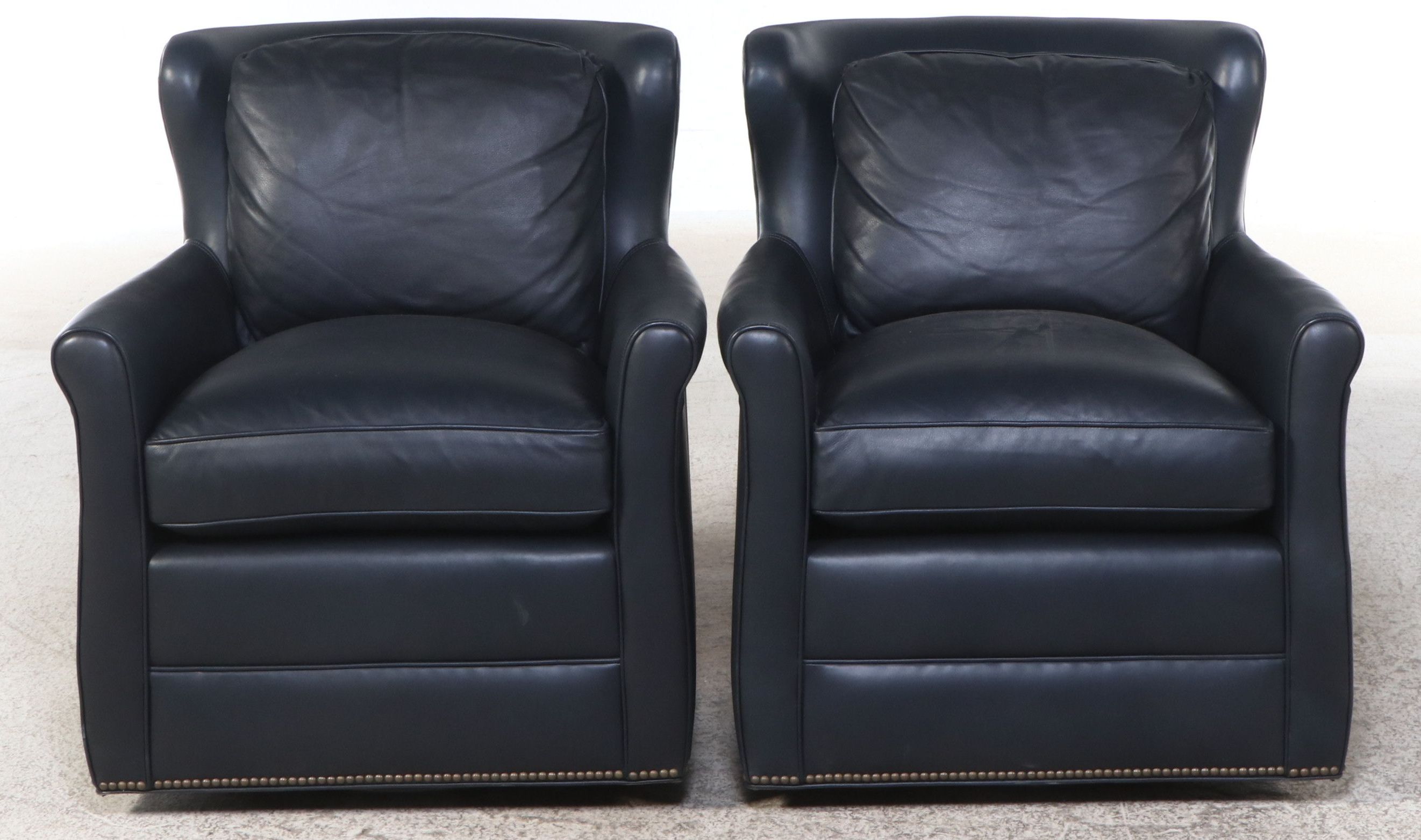 Pair of Ohio Hardwood Furniture Leather Upholstered Swivel Armchairs