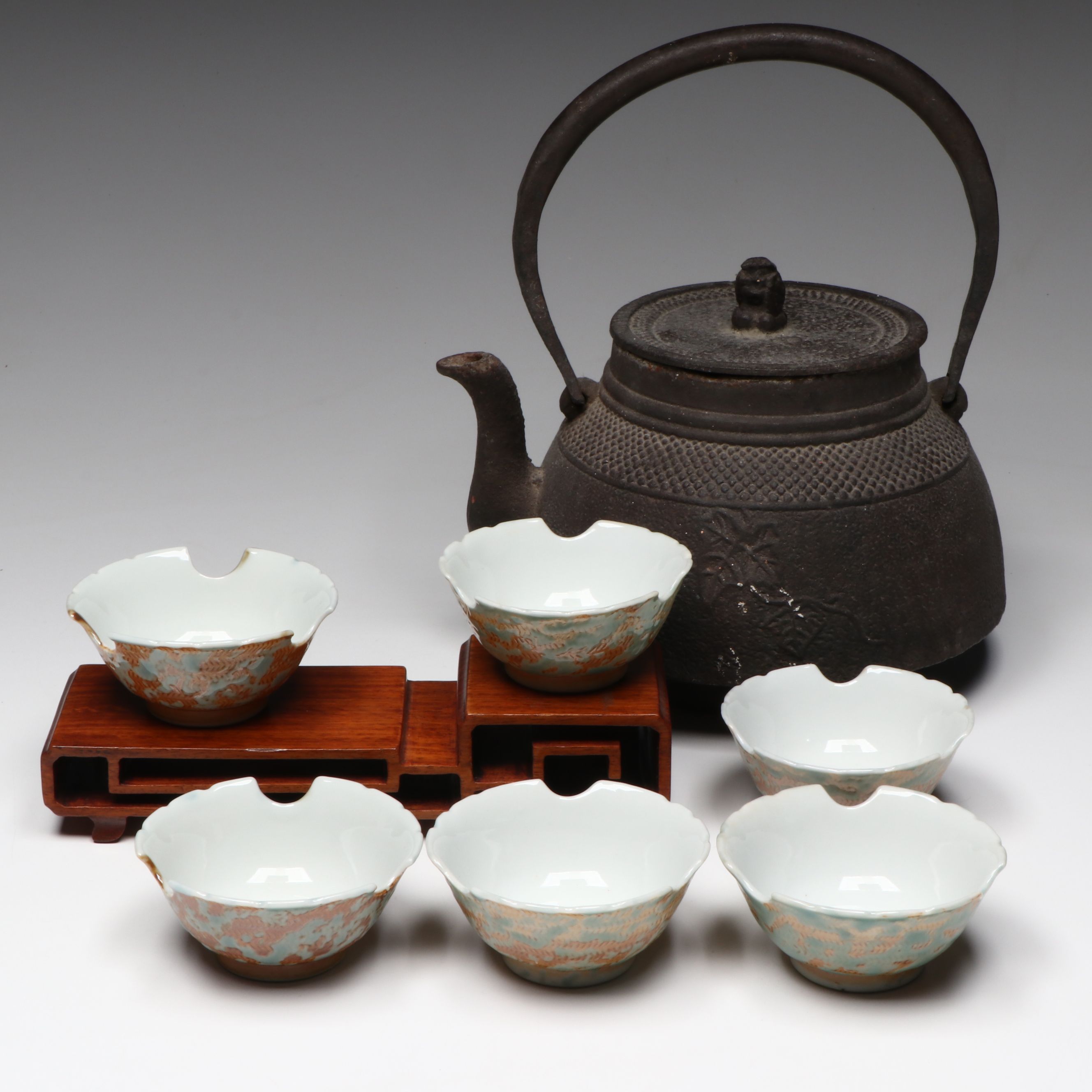 Cast Iron Teapot with Porcelain Cups and Wood Stand