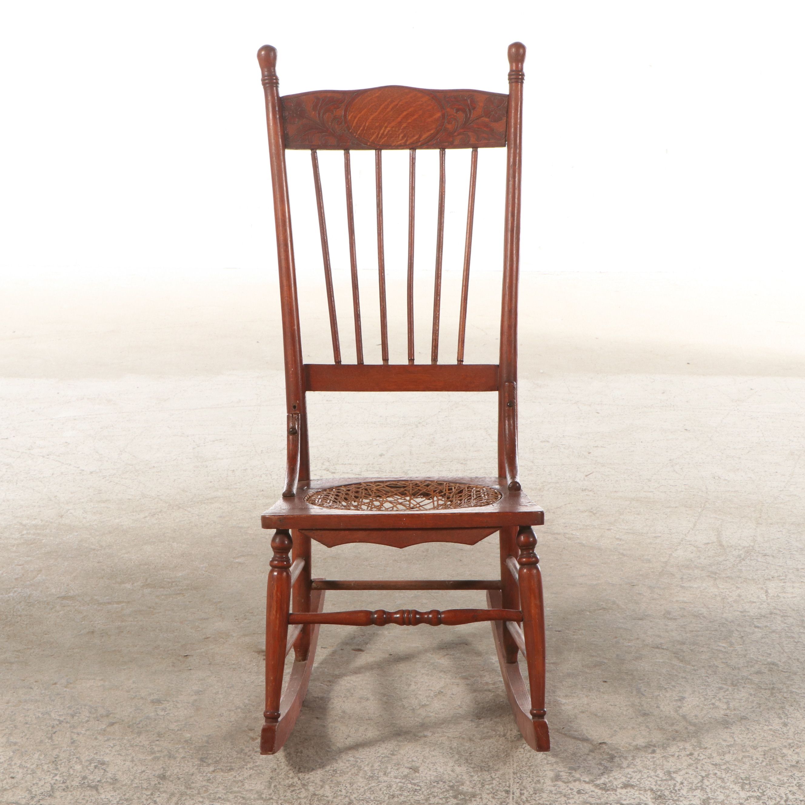 Late Victorian Carved Oak Rocking Chair with Cane Bottom Seat