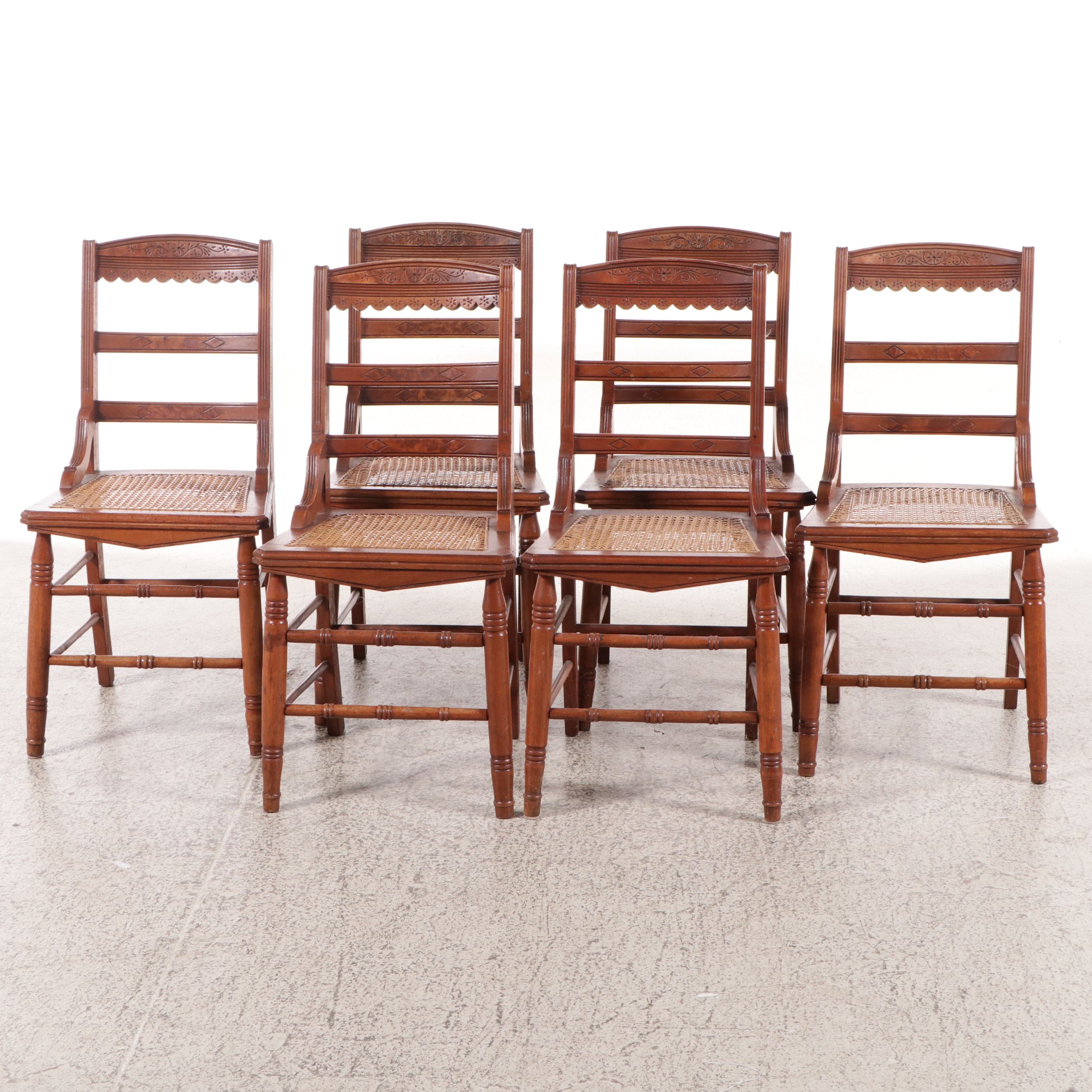 Set of Six Eastlake Style Incised Walnut Chairs with Cane Seats