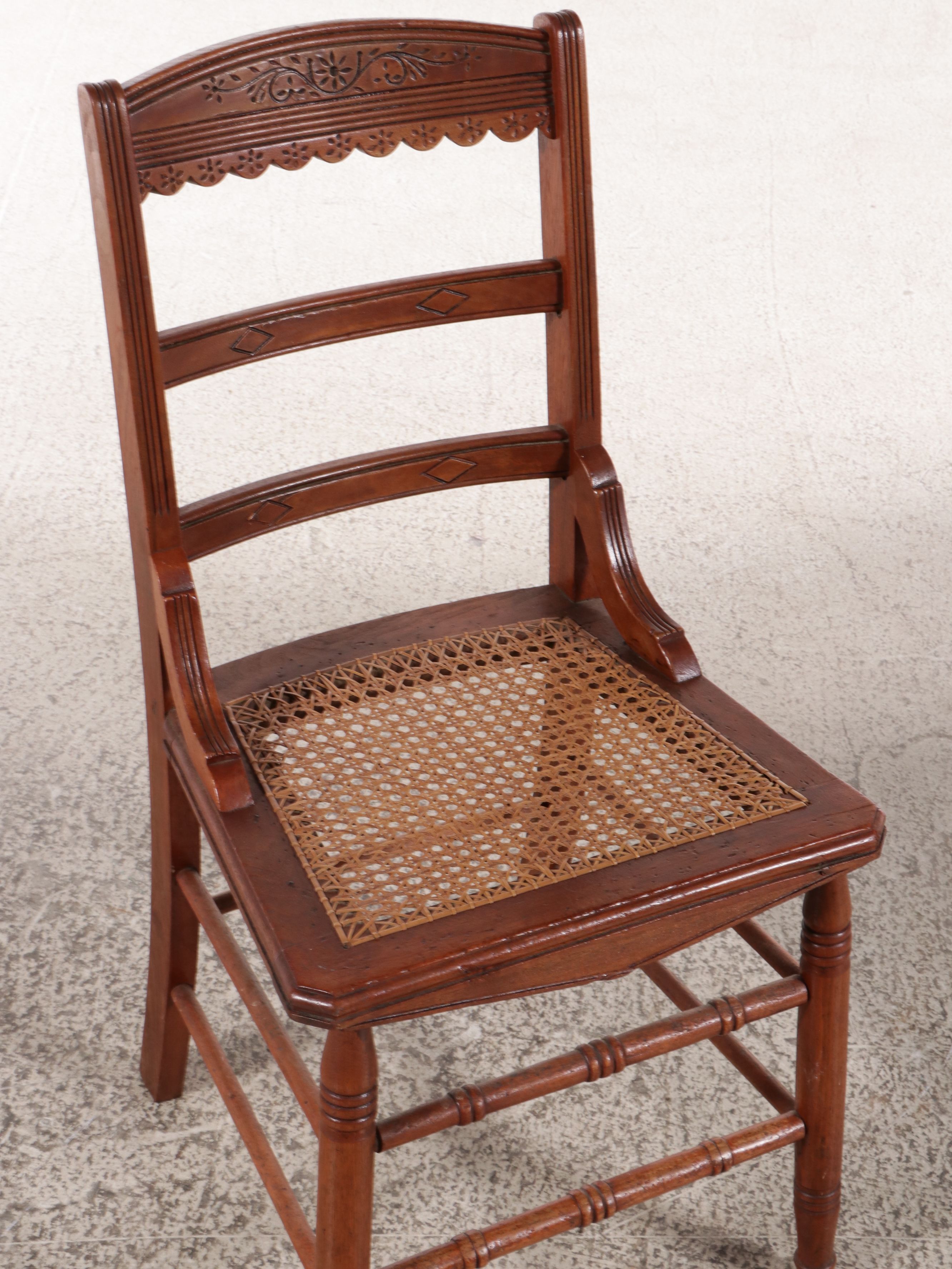 Set of Six Eastlake Style Incised Walnut Chairs with Cane Seats