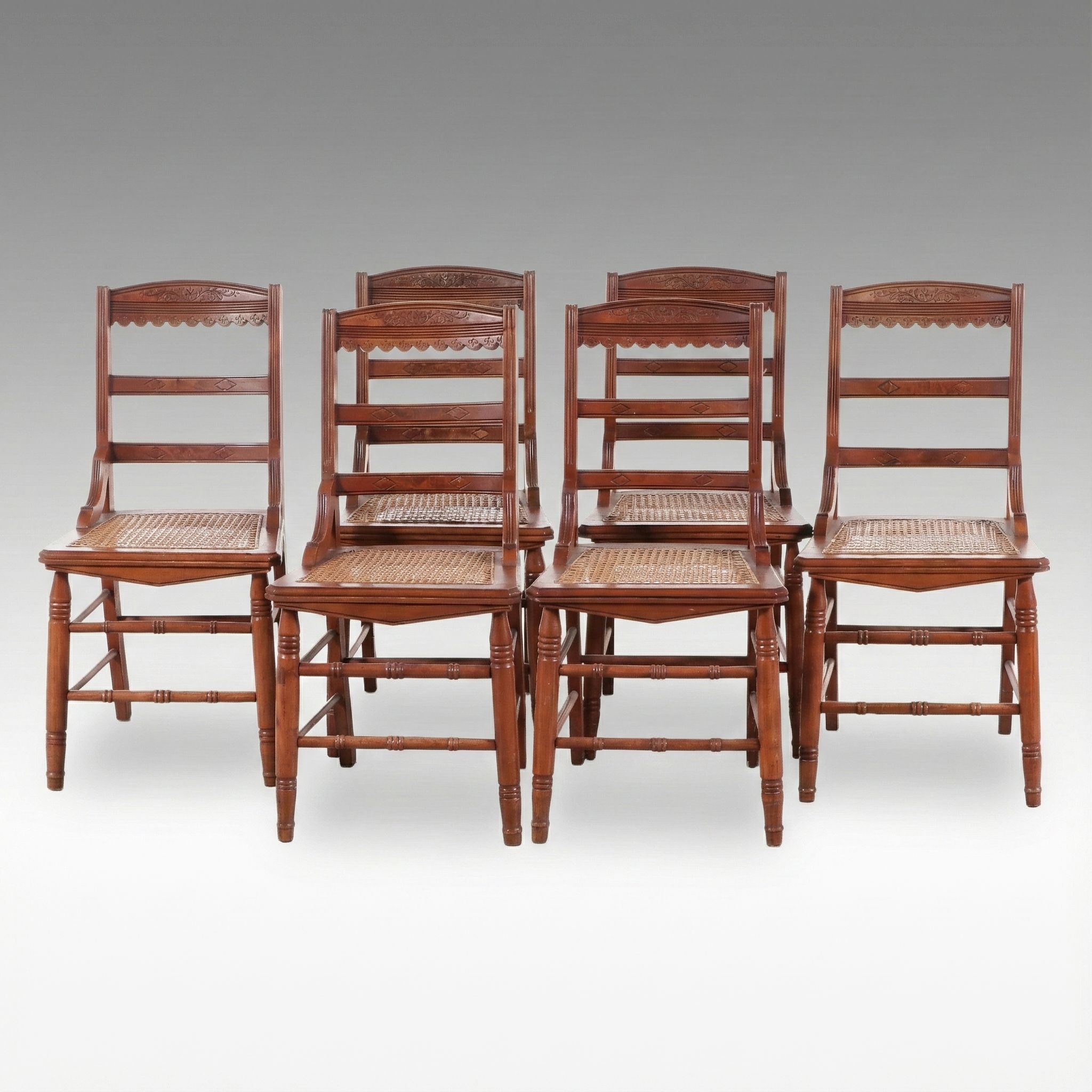 Set of Six Eastlake Style Incised Walnut Chairs with Cane Seats