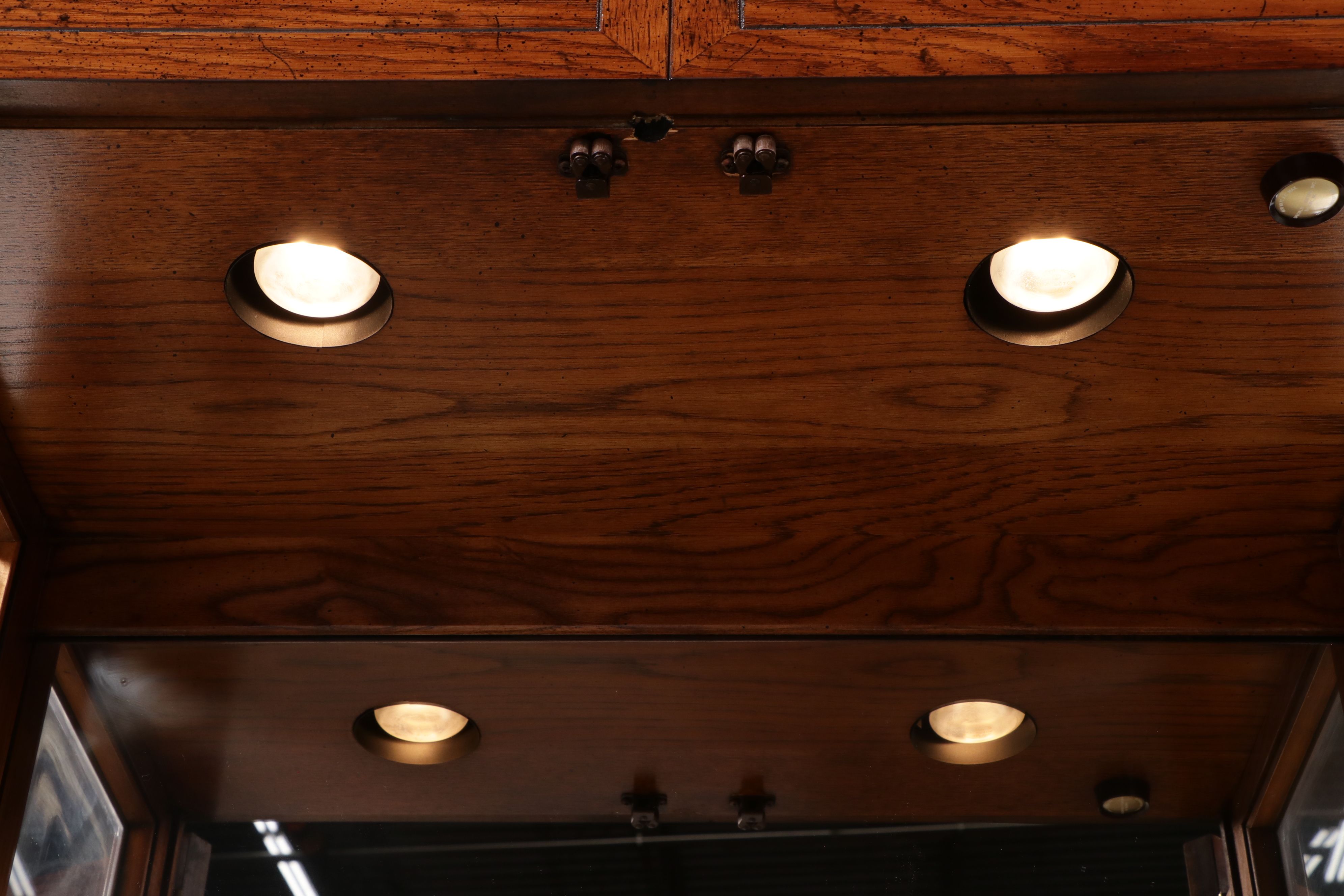 Henredon Oak Finish Mirrored Back Campaign Style Display Cabinets