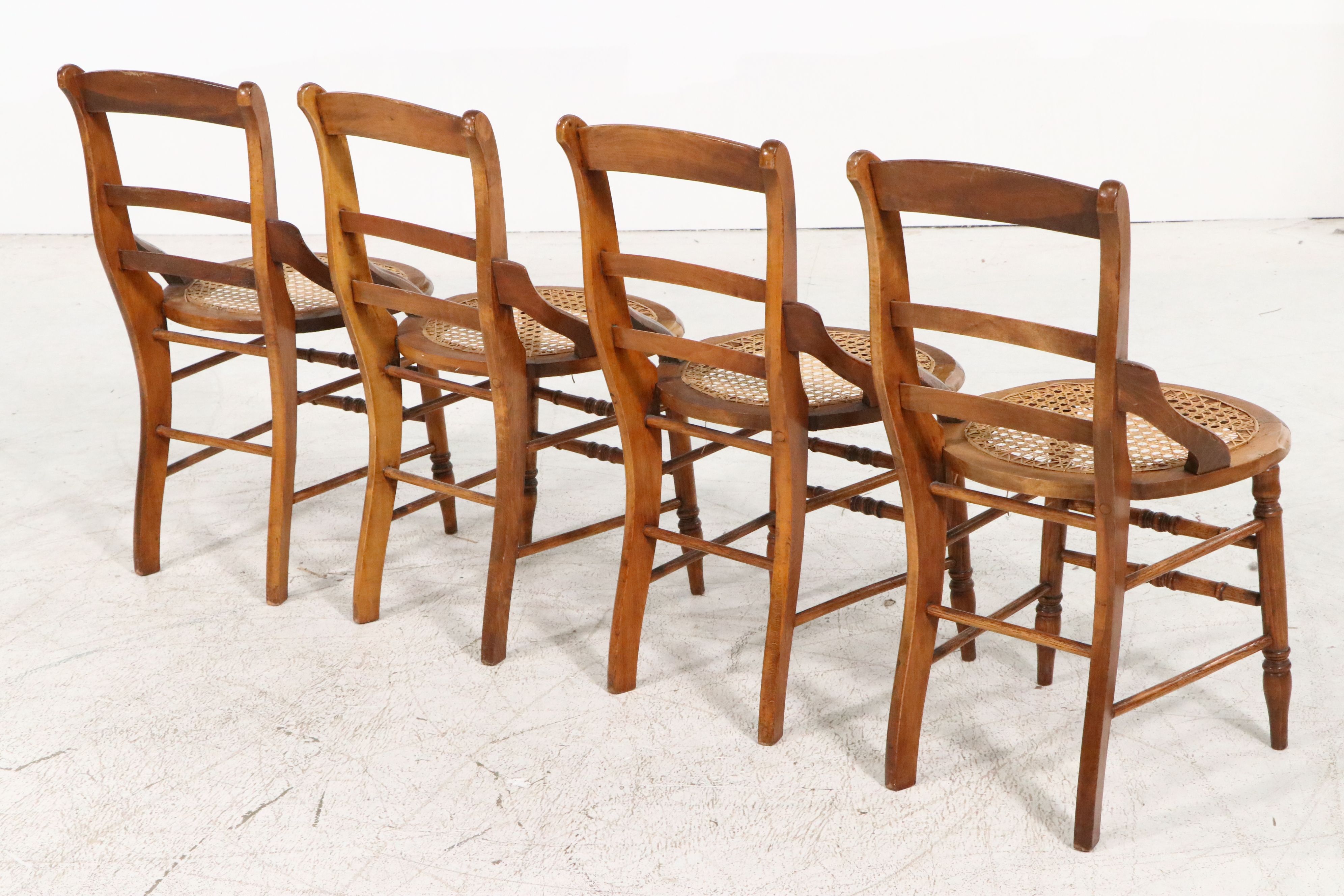 Set of Four Eastlake Style Birdseye Maple Accented Cane Bottom Chairs
