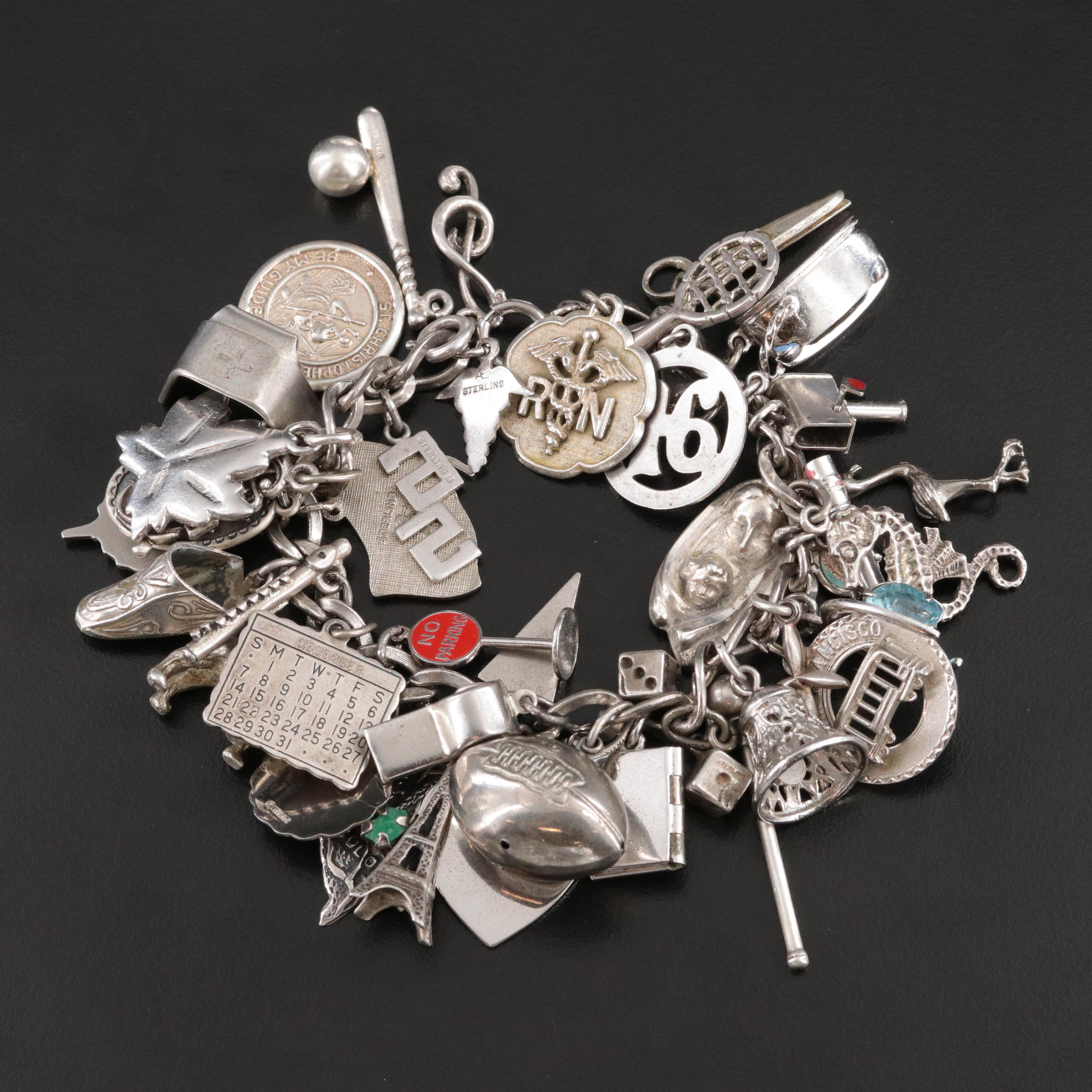 Sterling Charm Bracelet Including Emerald, Enamel and Articulated