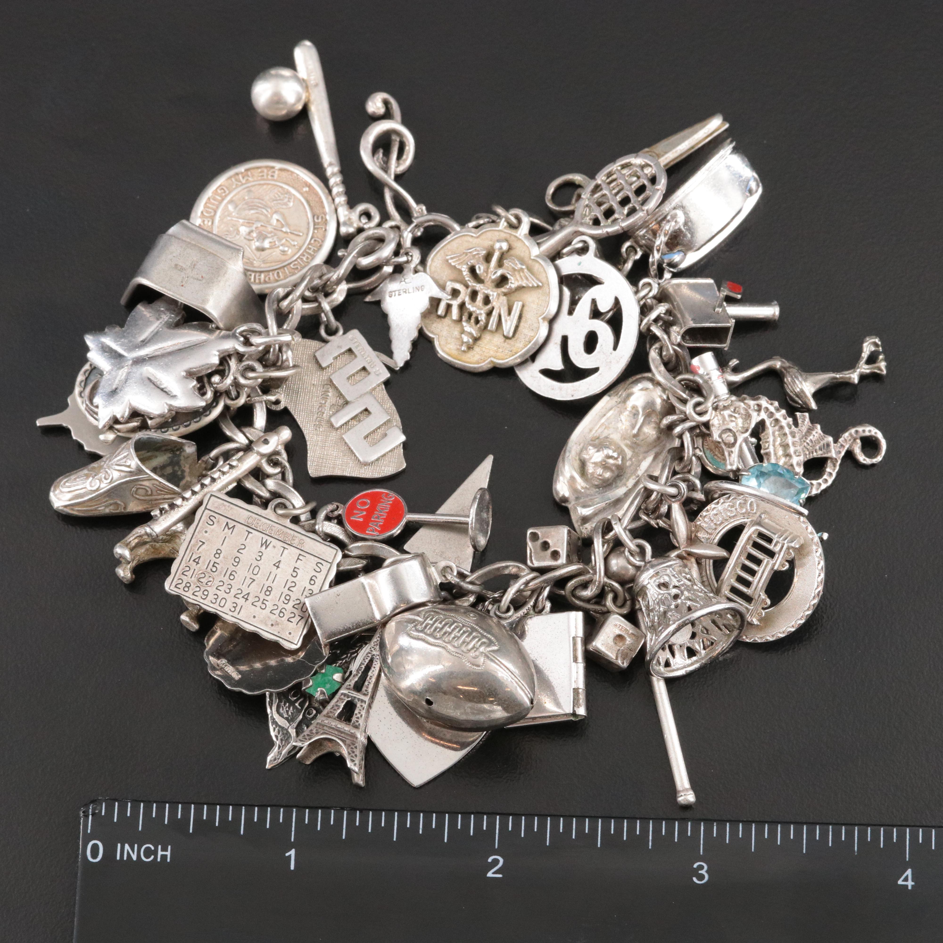 Sterling Charm Bracelet Including Emerald, Enamel and Articulated