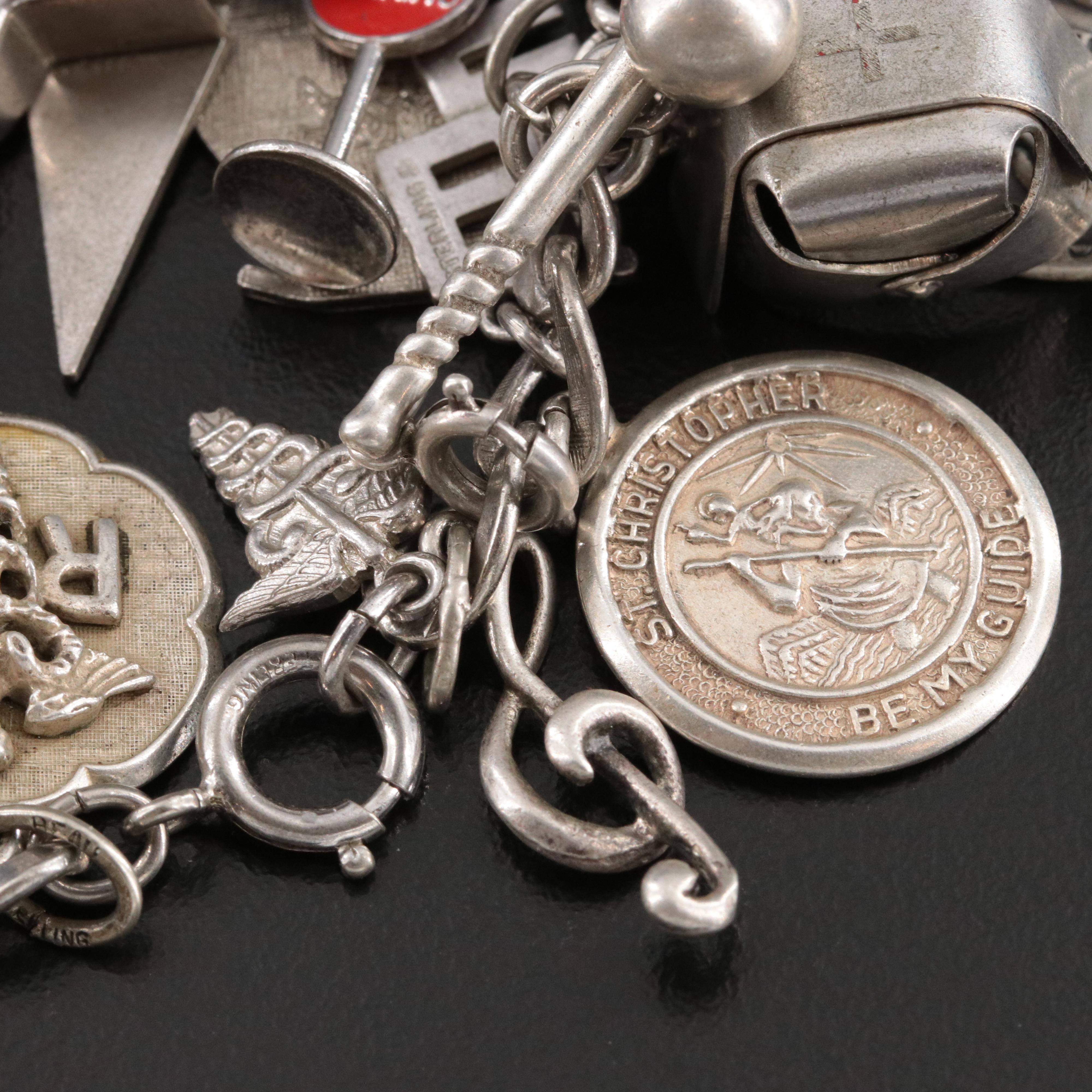 Sterling Charm Bracelet Including Emerald, Enamel and Articulated