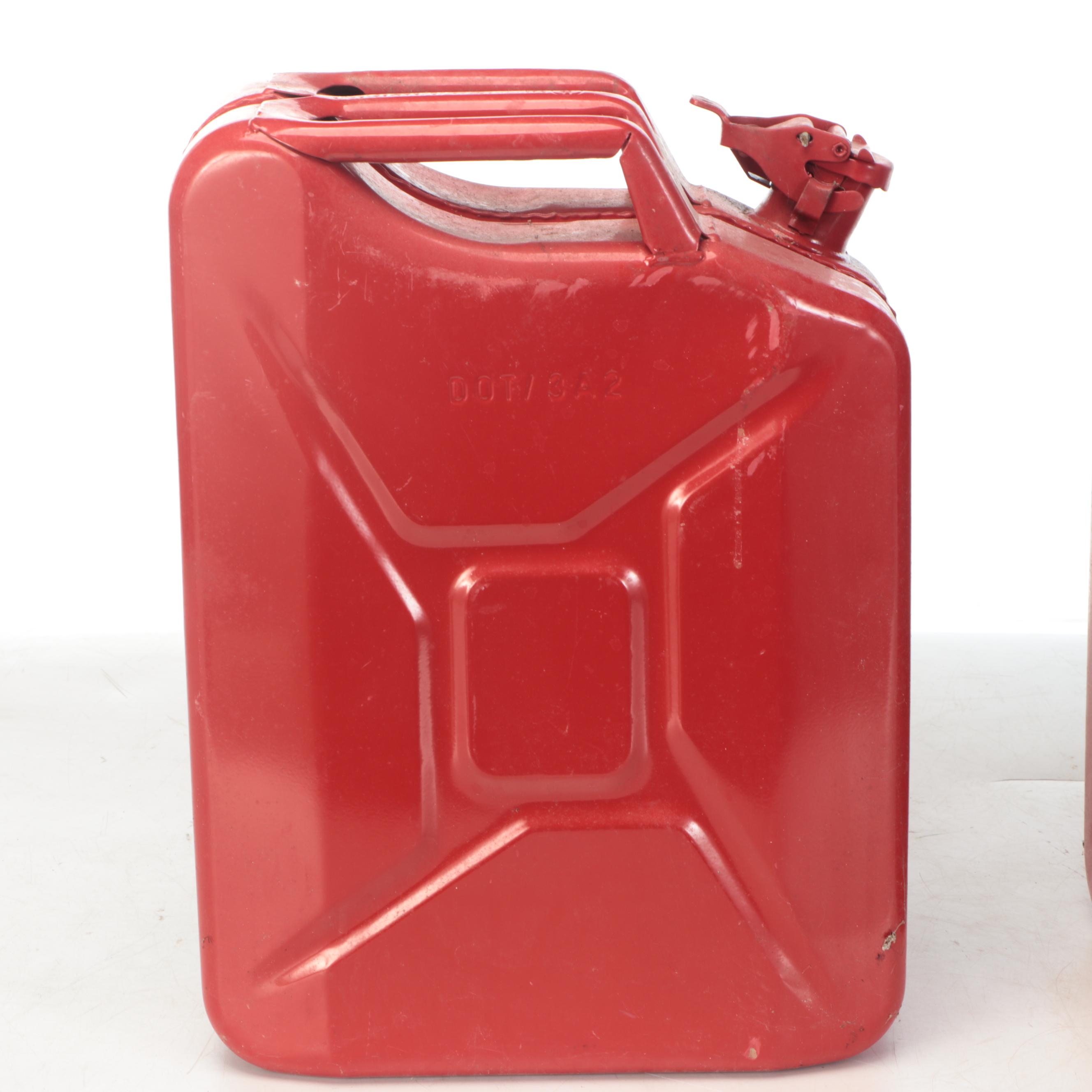 Two Red Metal Gasoline Cans
