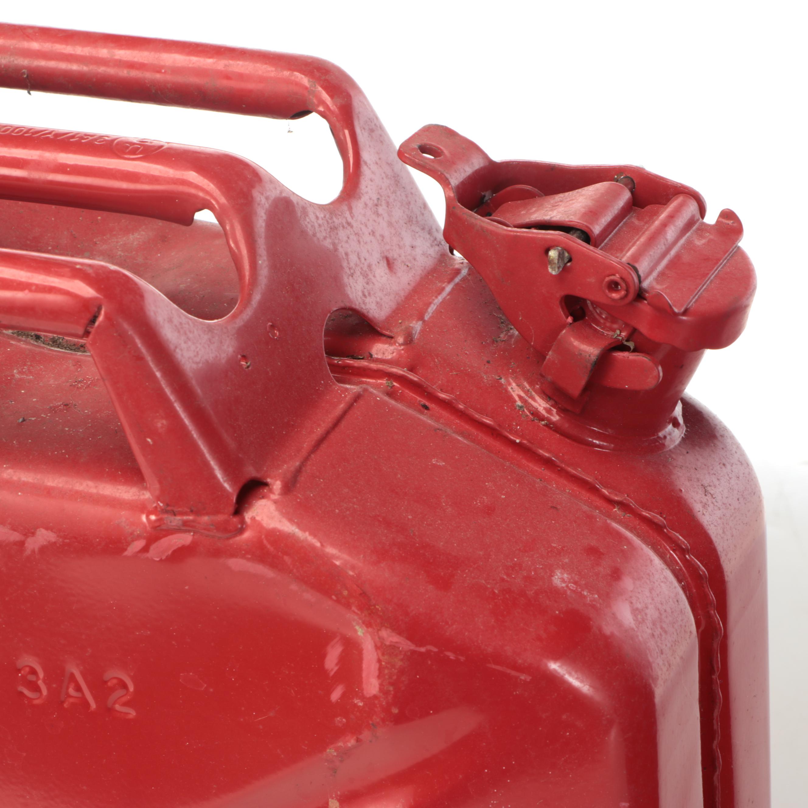 Two Red Metal Gasoline Cans