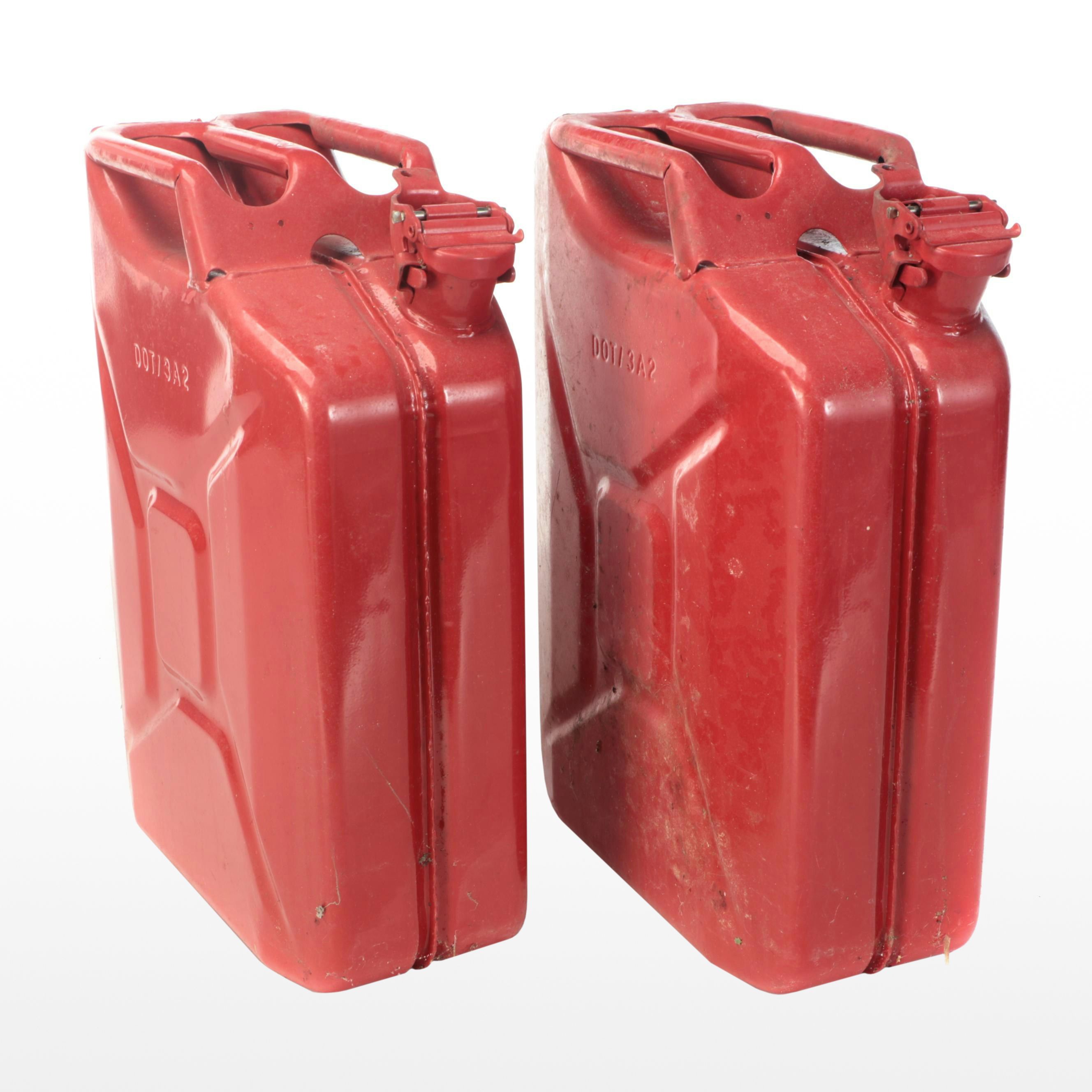 Two Red Metal Gasoline Cans