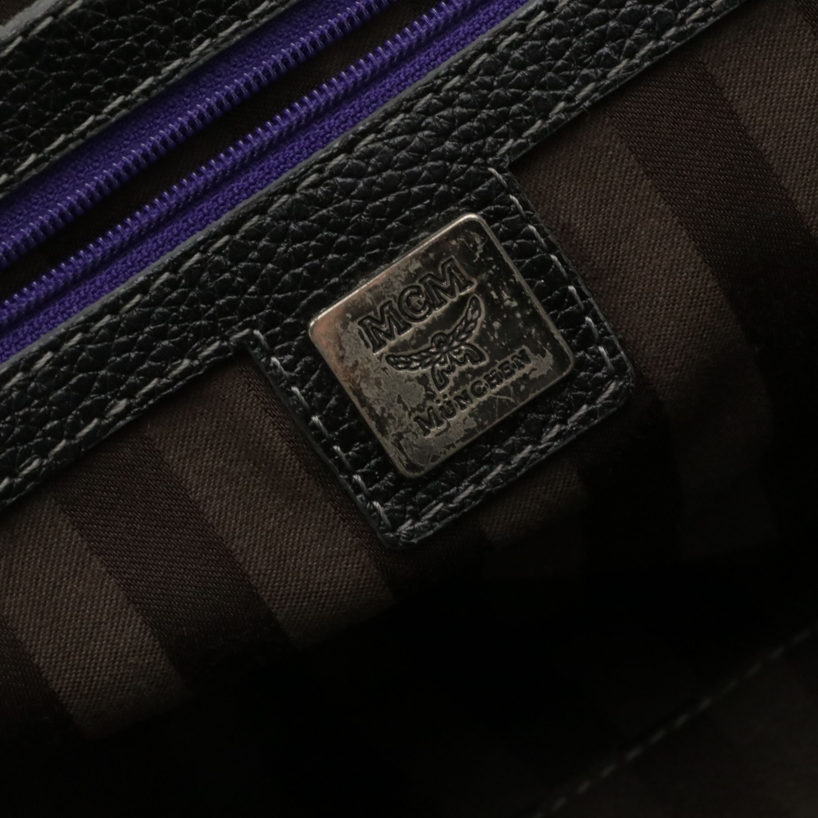 MCM Domed Boston Handbag in Logo Studded Black Leather