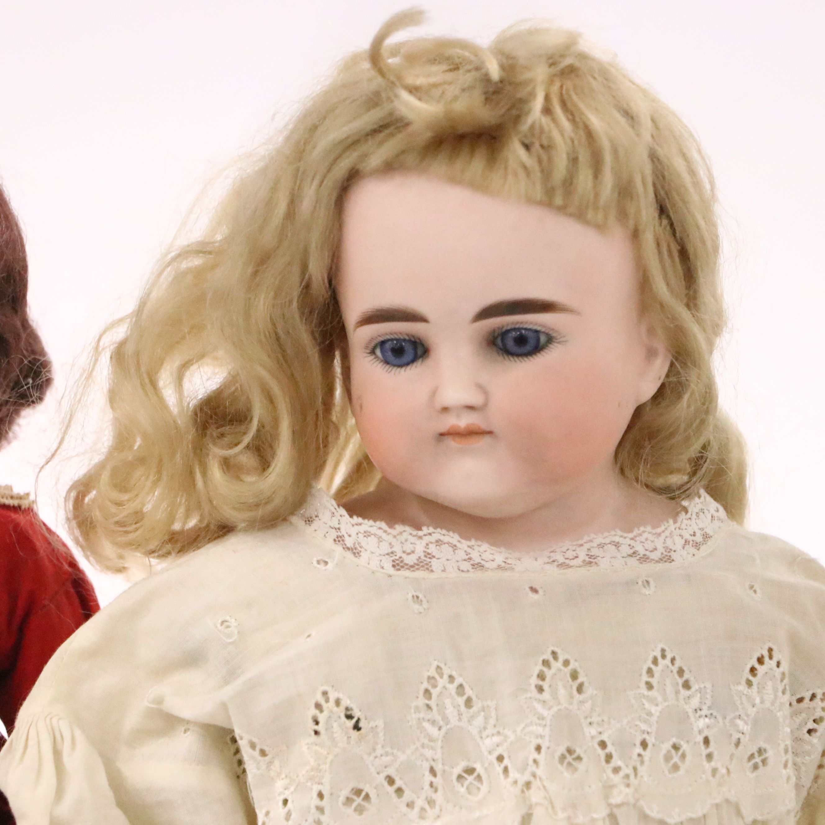 German Bisque Lady Doll with Molded Blonde Hair and Collar with Other Dolls