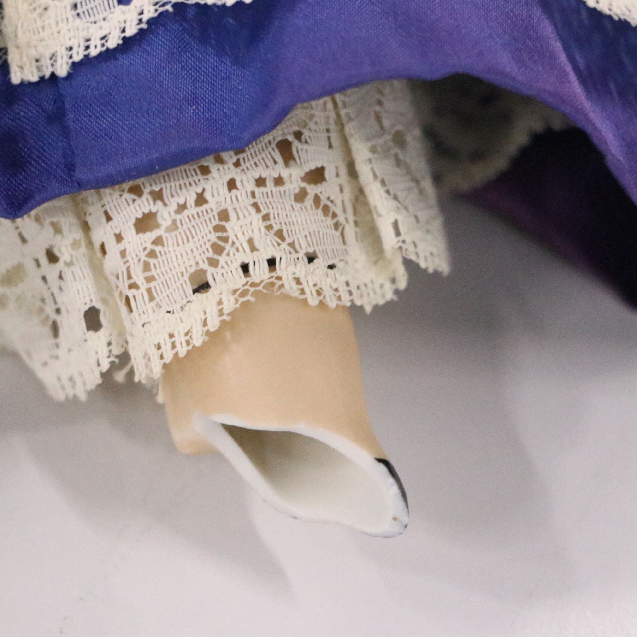 German Bisque Lady Doll with Molded Blonde Hair and Collar with Other Dolls