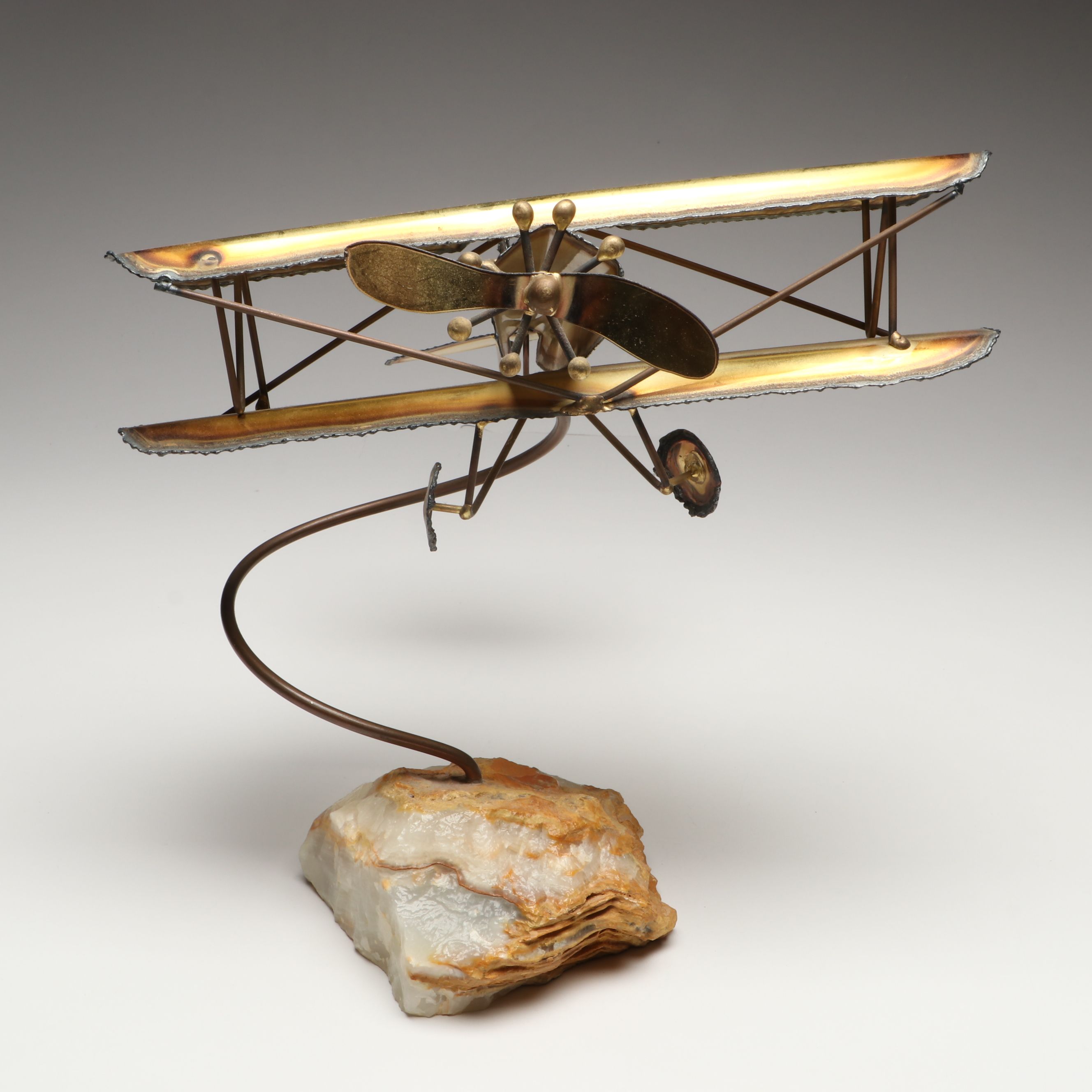 Handcrafted Metal Biplane Sculpture with Toy Cannons
