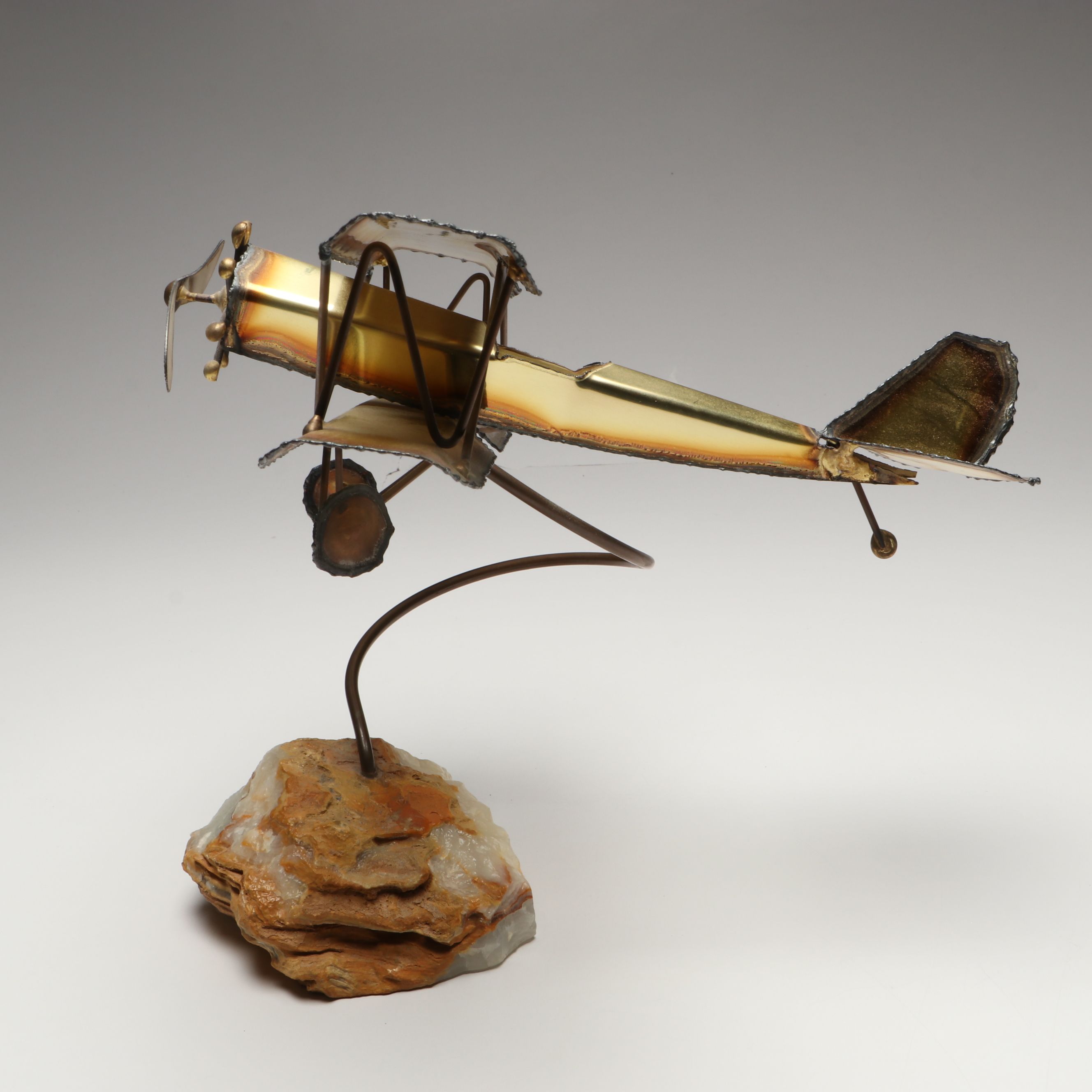 Handcrafted Metal Biplane Sculpture with Toy Cannons