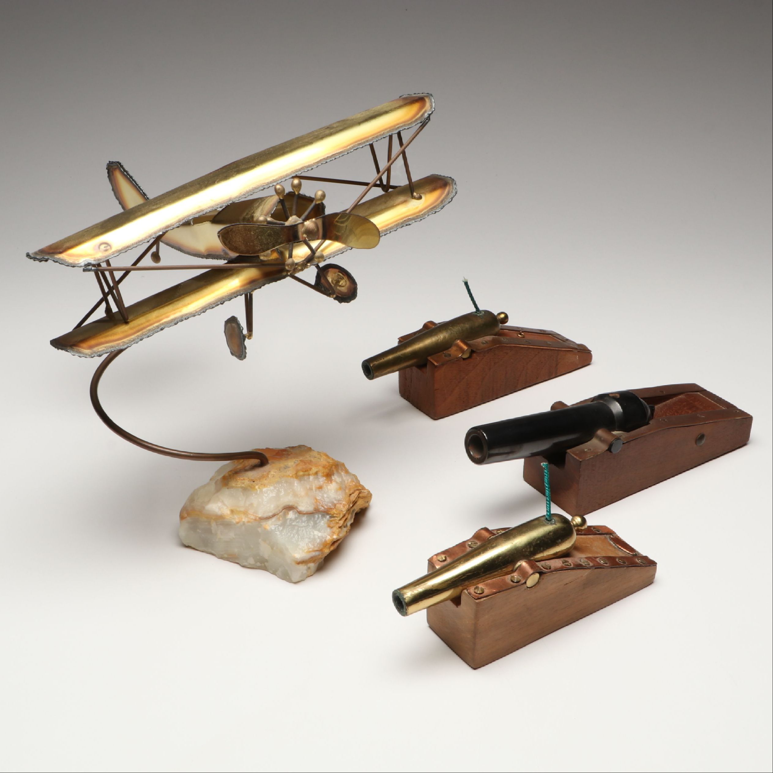 Handcrafted Metal Biplane Sculpture with Toy Cannons